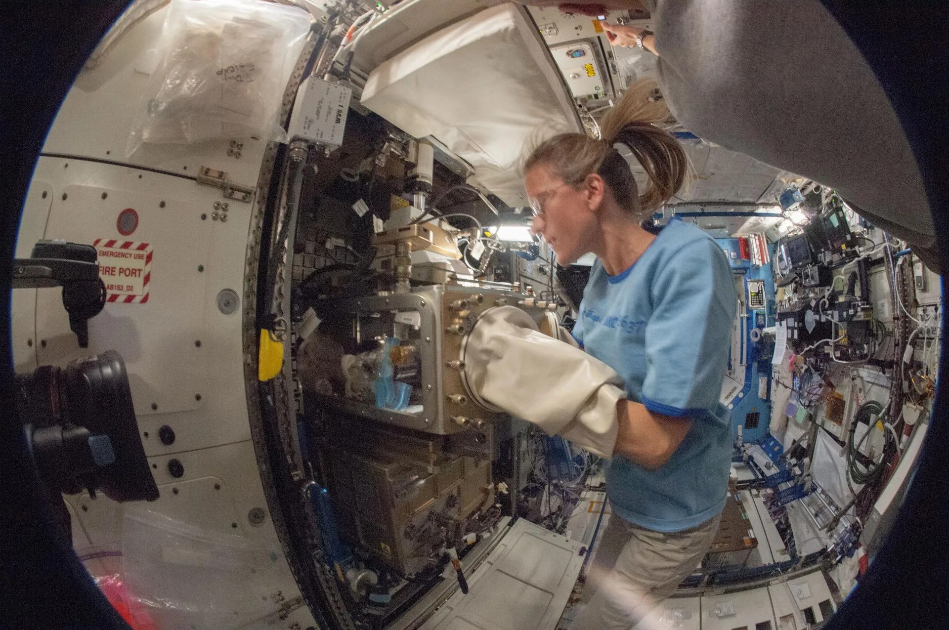 A photo of NASA astronaut Karen Nyberg conducting a session with the Advanced Colloids Experiment (ACE)-1 sample preparation at the Light Microscopy Module in the Fluids Integrated Rack / Fluids Combustion Facility.