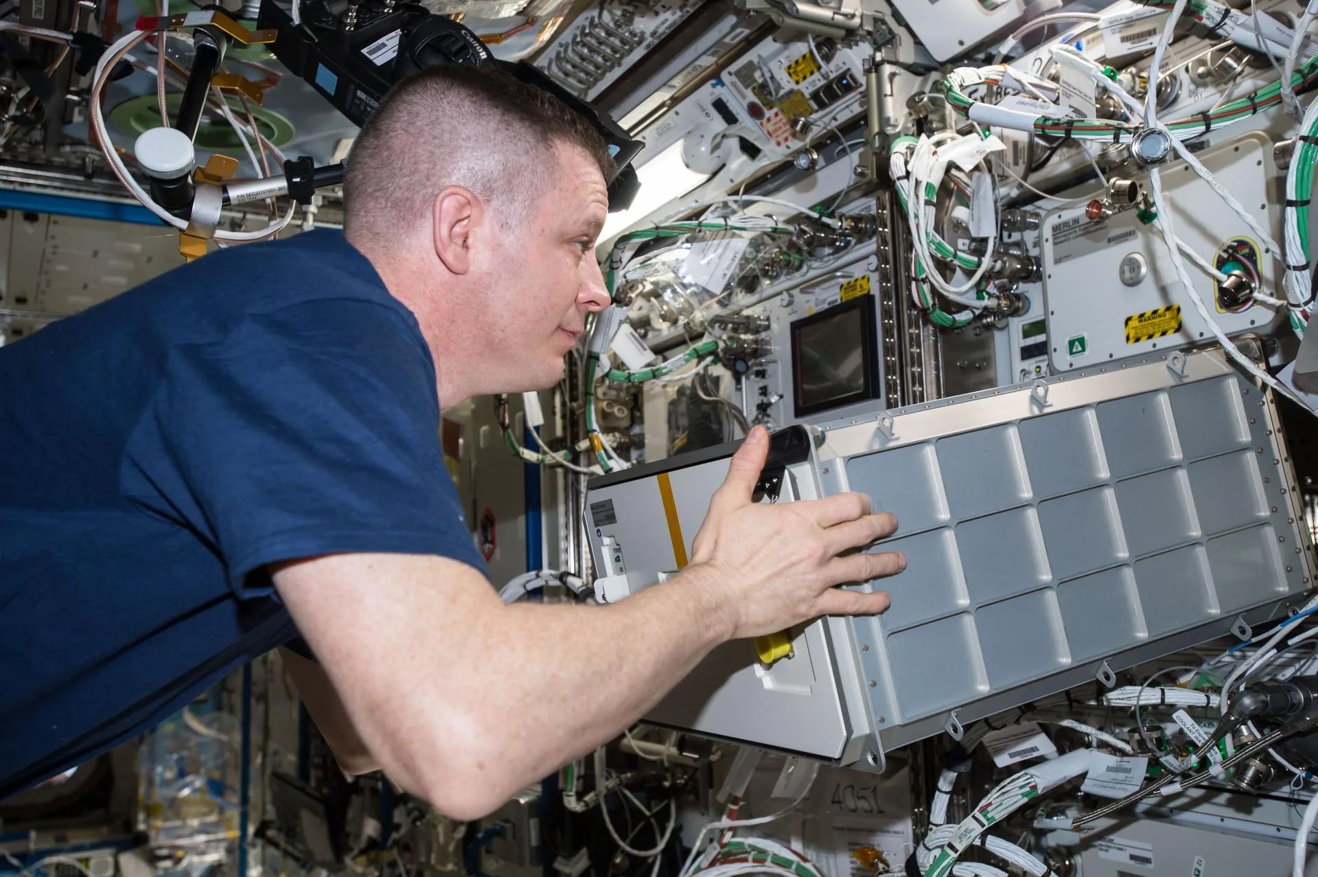 A photo of NASA astronaut Jack Fischer installing the Biological Research In Canisters (BRIC) Light Emitting Diode (LED) box for future BRIC-LED experiments.