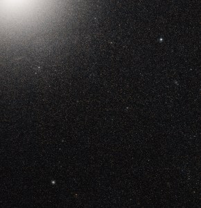 thousands of stars can be seen in the corner of a galaxy that is void of gas and dust.