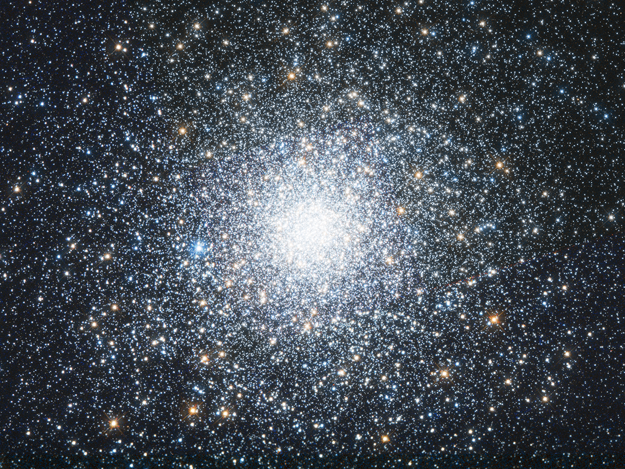 A bright cluster of white and orange stars, concentrated more densely at the center.