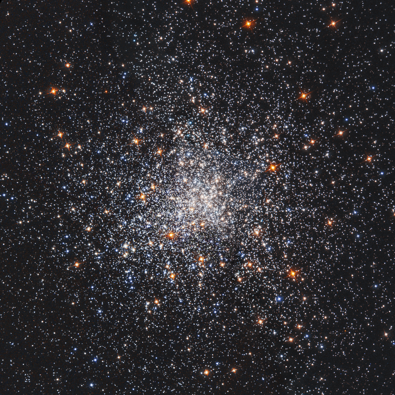 A cluster or white and orange stars, more densely concentrated at the center.
