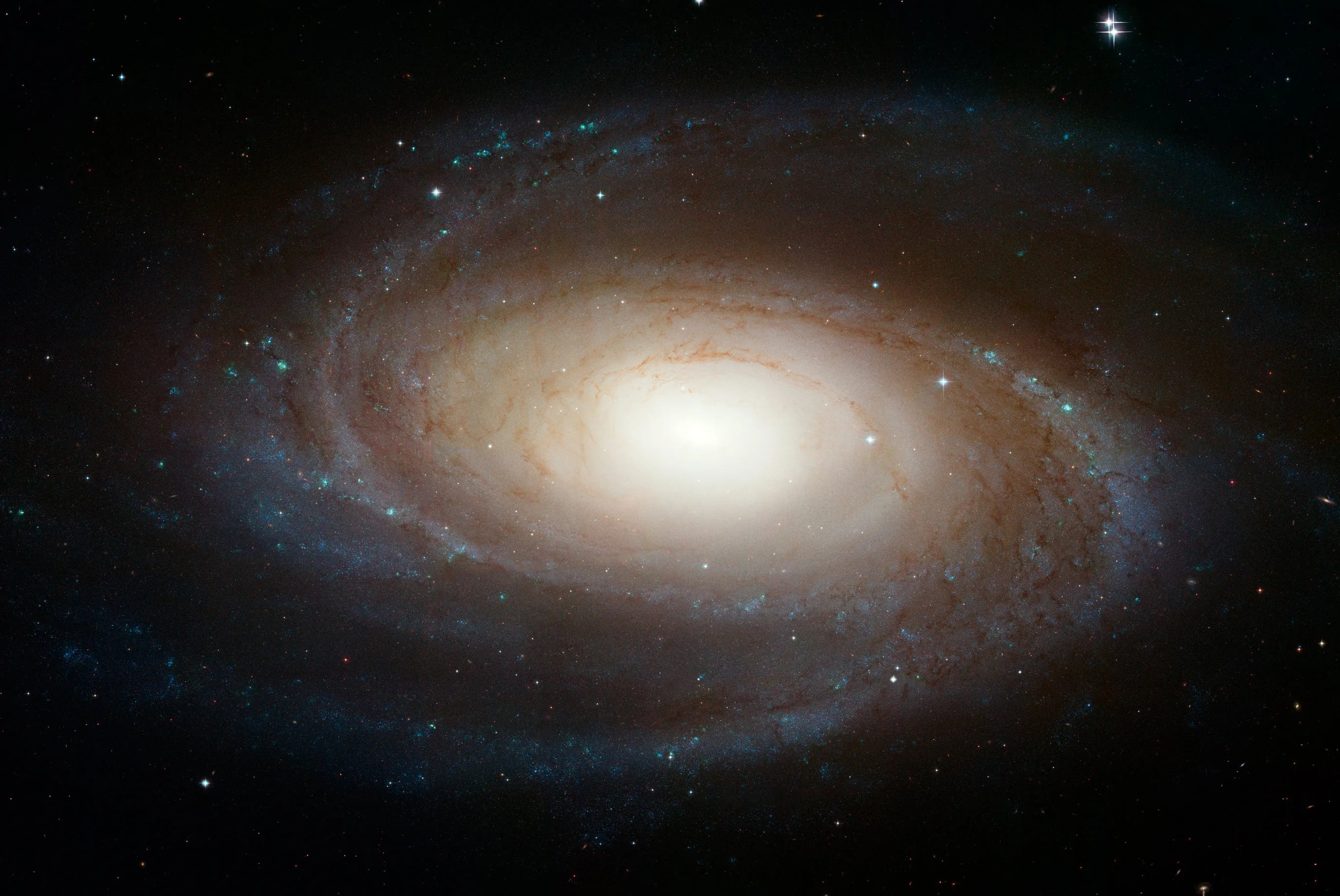 A bright spiral galaxy with a large, yellow core, with small spiral arms surrounding it.