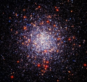 A spherical cluster of bright white, red, and blue stars.