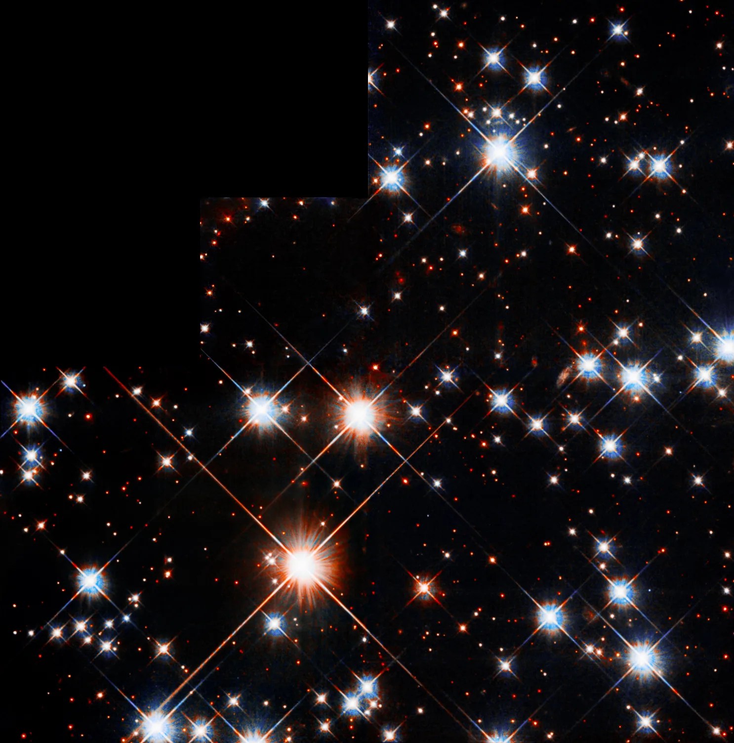 Several very bright stars are scattered throughout the field of view, with many fainter ones behind them. Of the four brightest stars, two have a reddish-orange hue, one is reddish-white, and one is bluish-white.