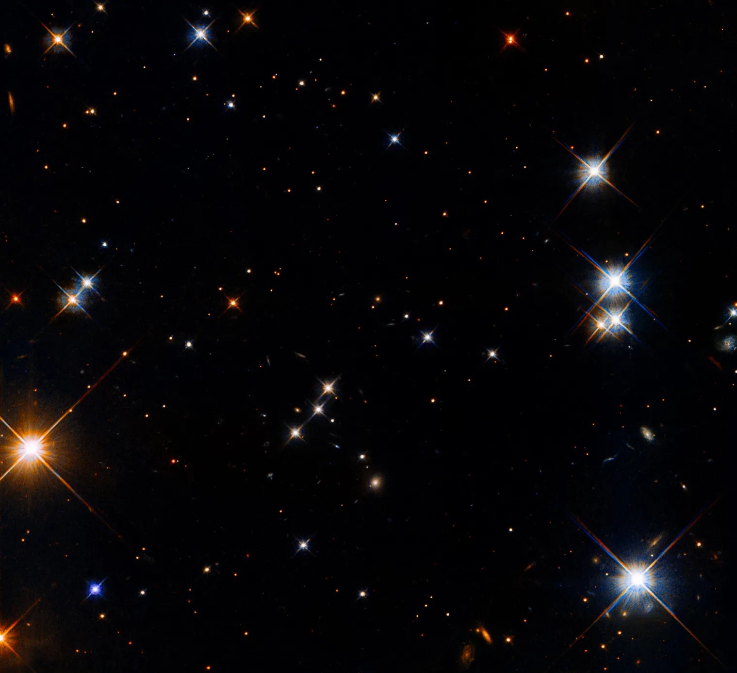 Scattered white and reddish stars on a black background, with the largest and brightest stars to the left and right of the image.