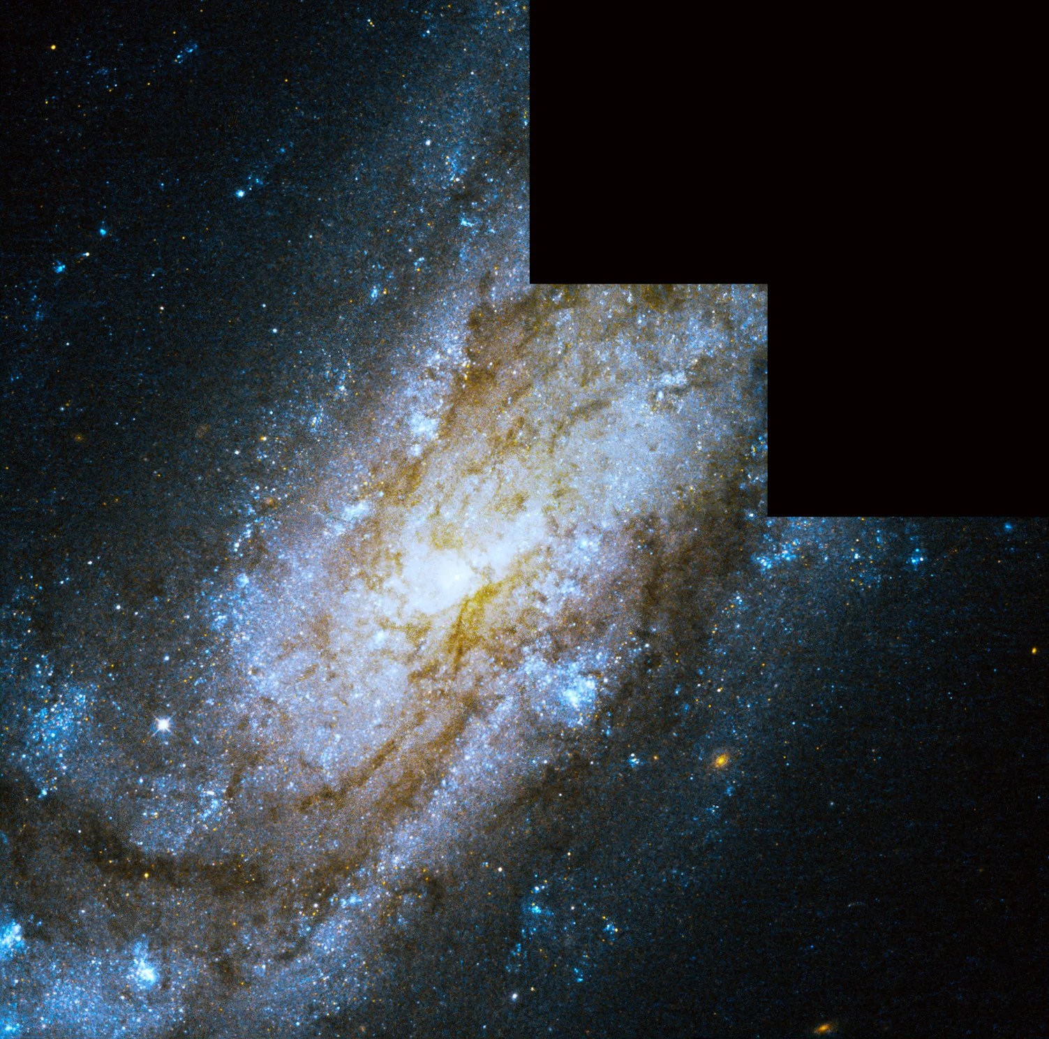 Large spiral galaxy, countless stars surround the bright center core of the galaxy in the middle of the image. The arms of the galaxy are dusty red clouds of gas enmeshed by blue stars throughout.