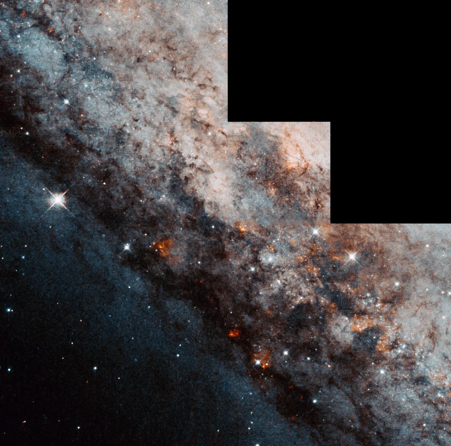 Dark lanes of dust and gas are scattered with red and white stars. The image has the step-shape format caused by the WFPC2 camera.