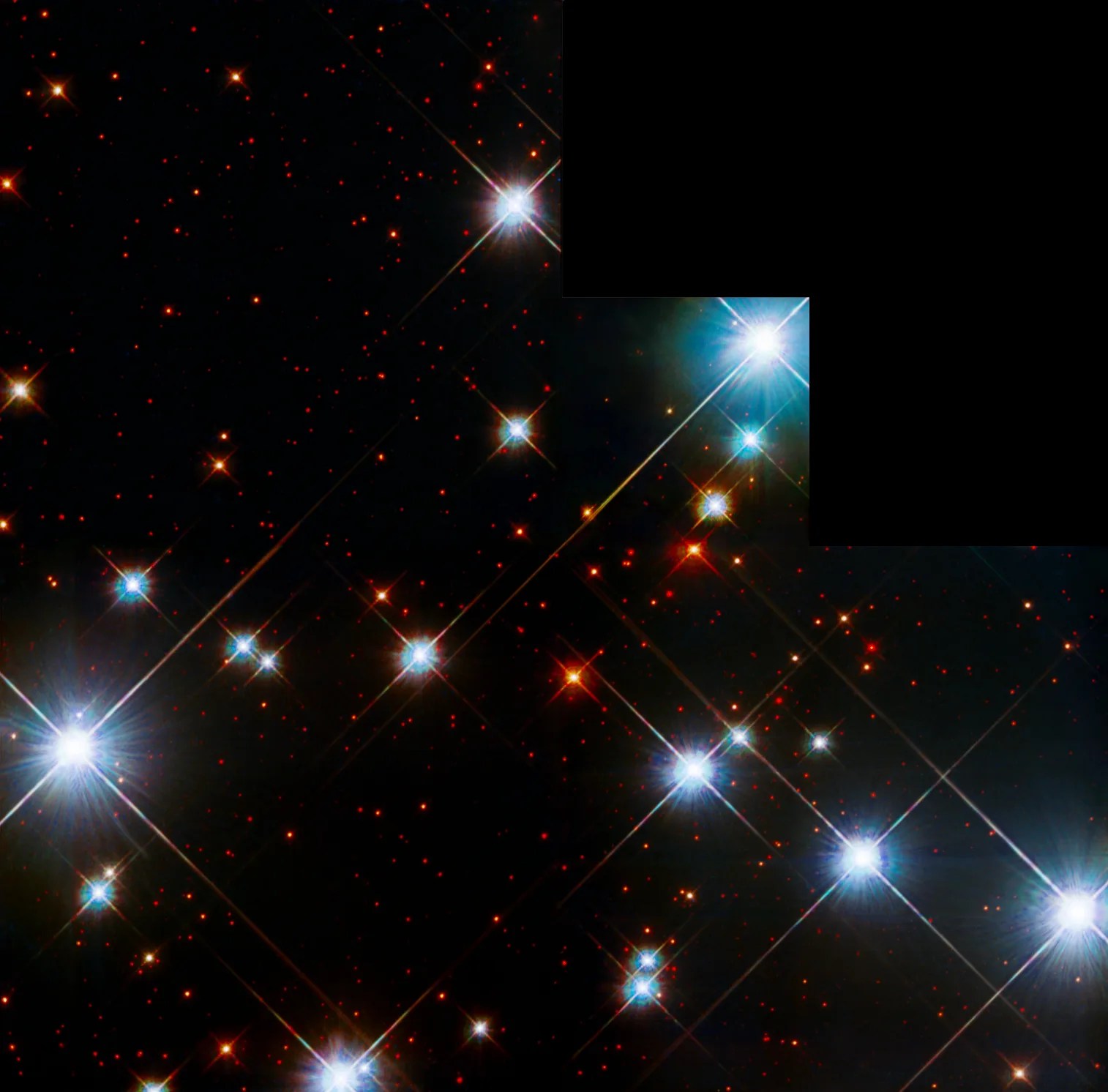 Several bright stars in colors of blue-white and red against the black background of space.
