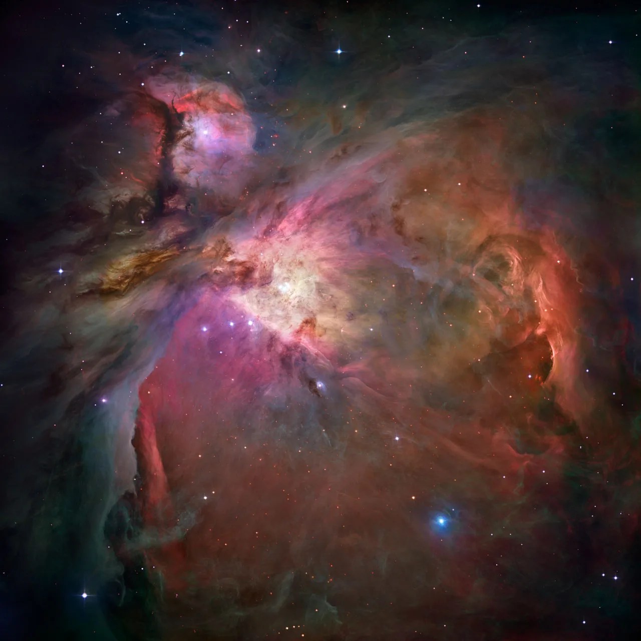 An intense cloud of red, purple, brown and similar color gas that is the Orion Nebula that includes pockets of starbirth.