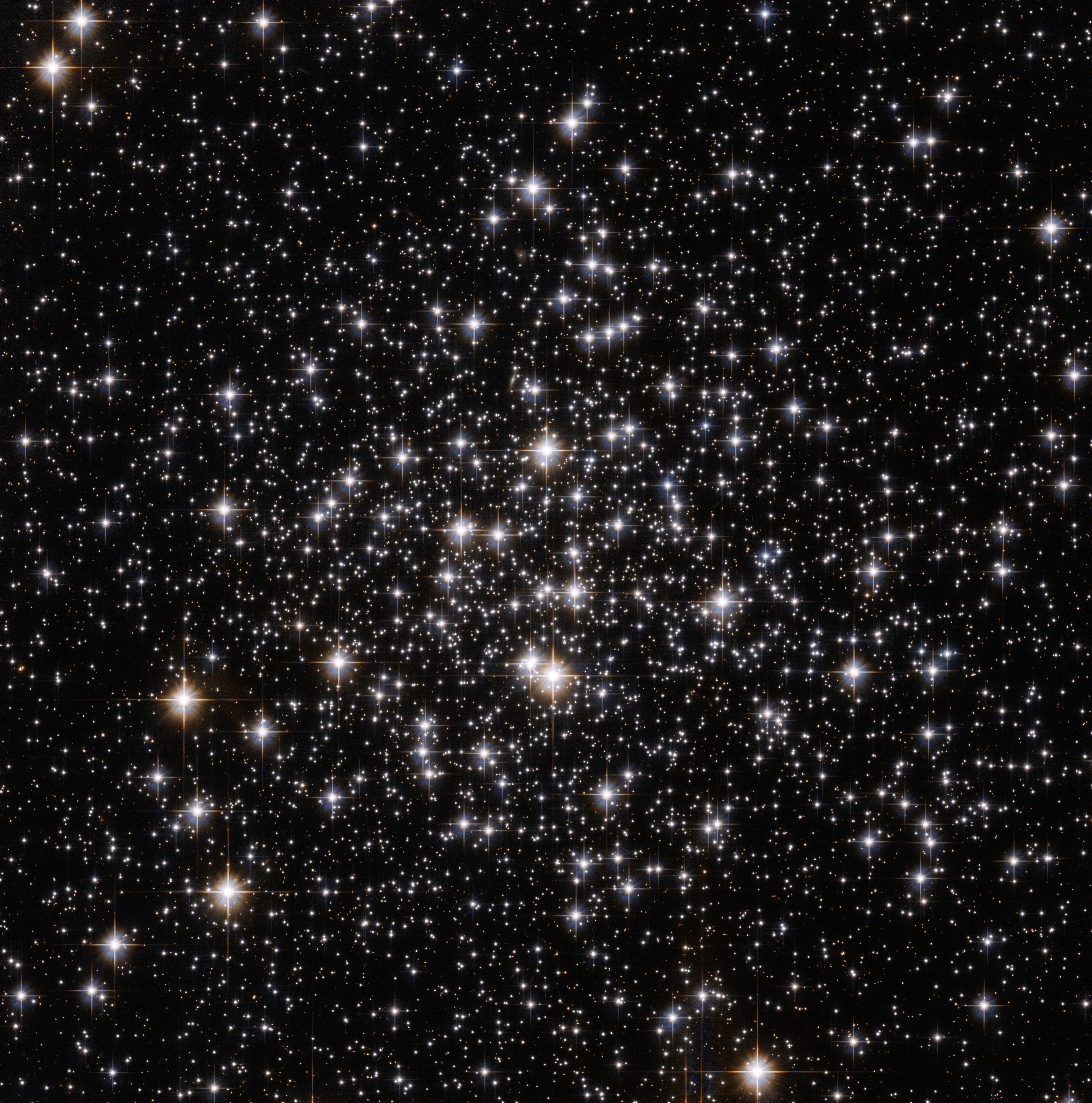 Several stars shine against black space.