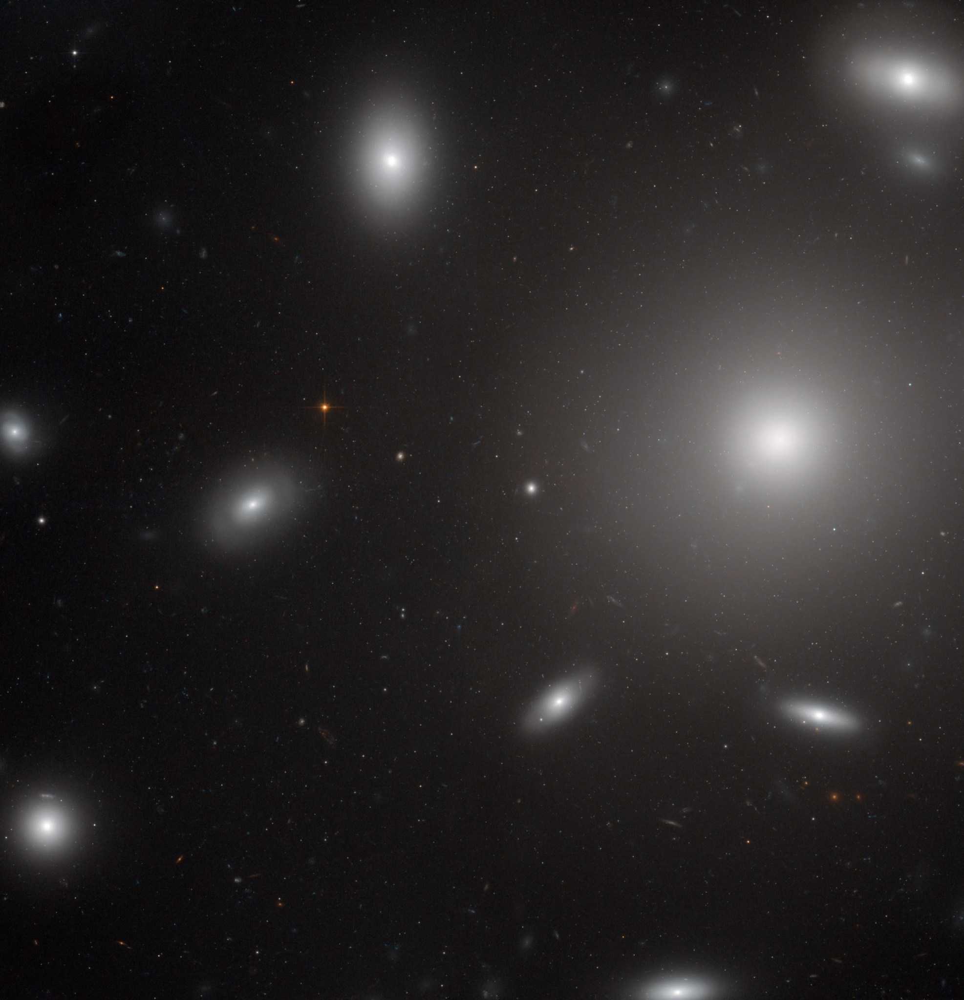 White blobs of stars around on big one