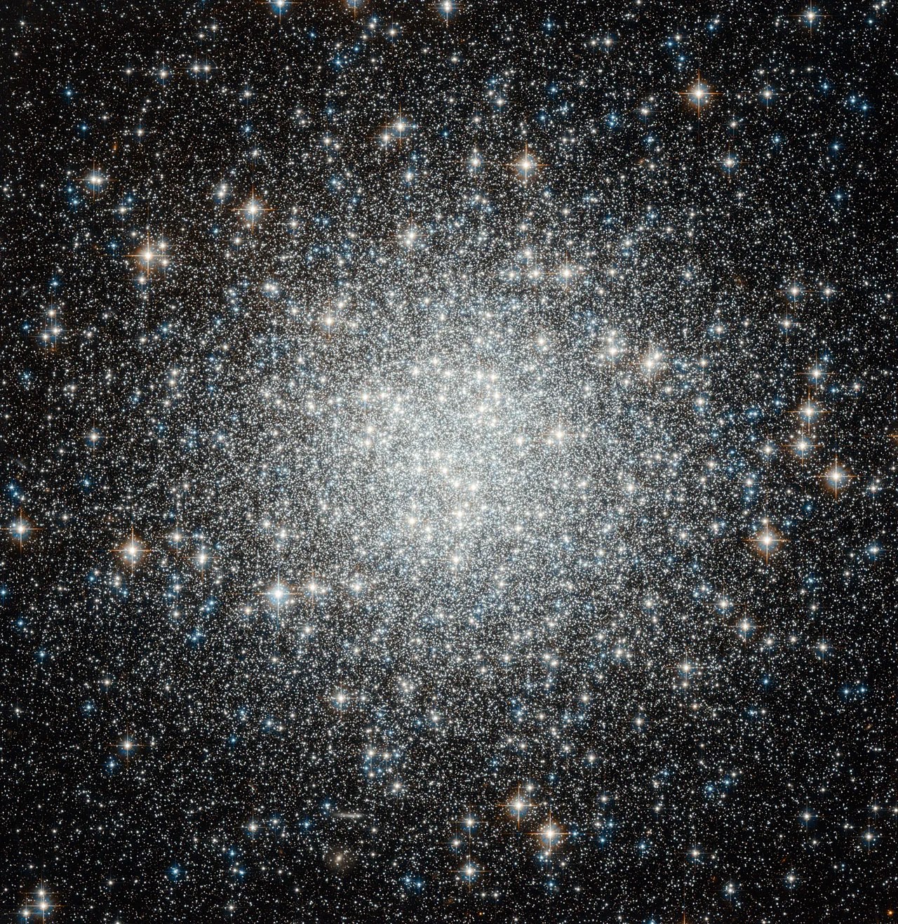 Large galaxy that's globular in shape, the closer to the center you get the brighter and whiter the image due to the amount of stars. Stars are everywhere in this image, of all sorts of colors.