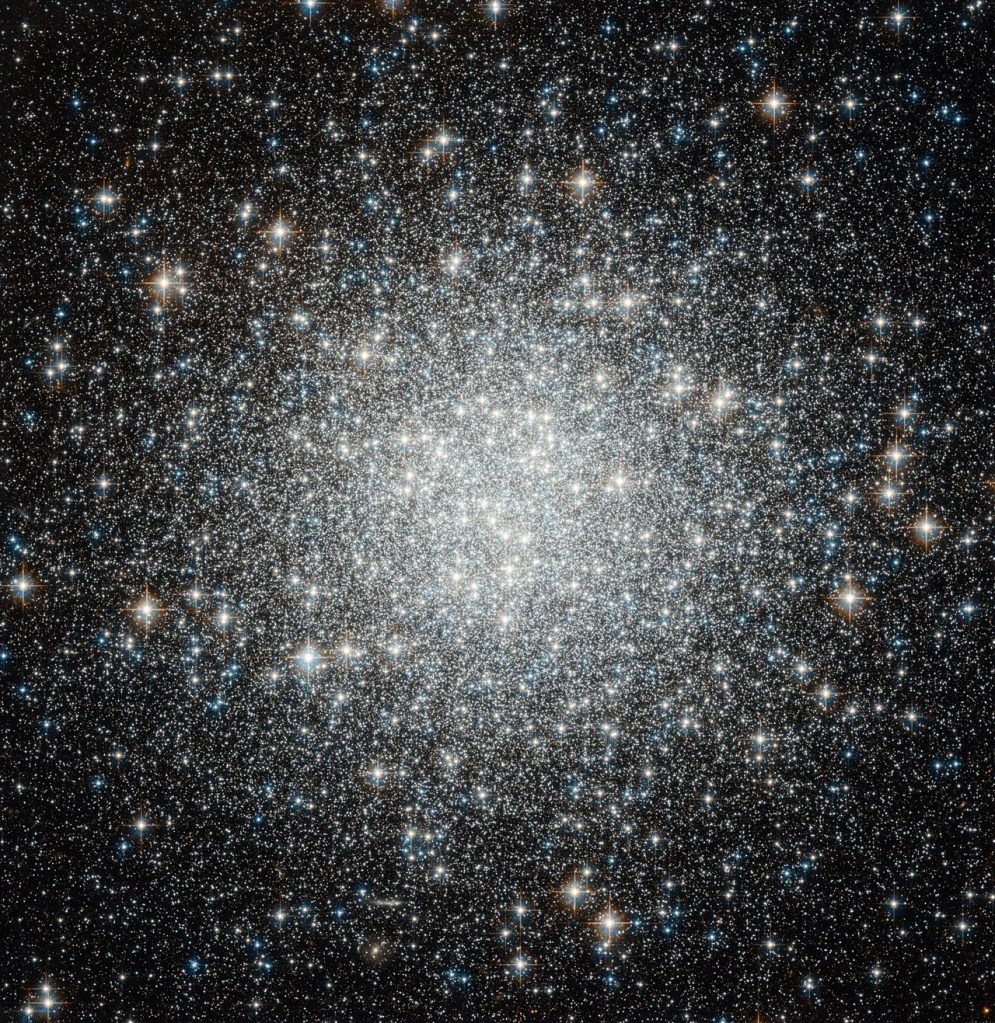 Large galaxy that's globular in shape, the closer to the center you get the brighter and whiter the image due to the amount of stars. Stars are everywhere in this image, of all sorts of colors.