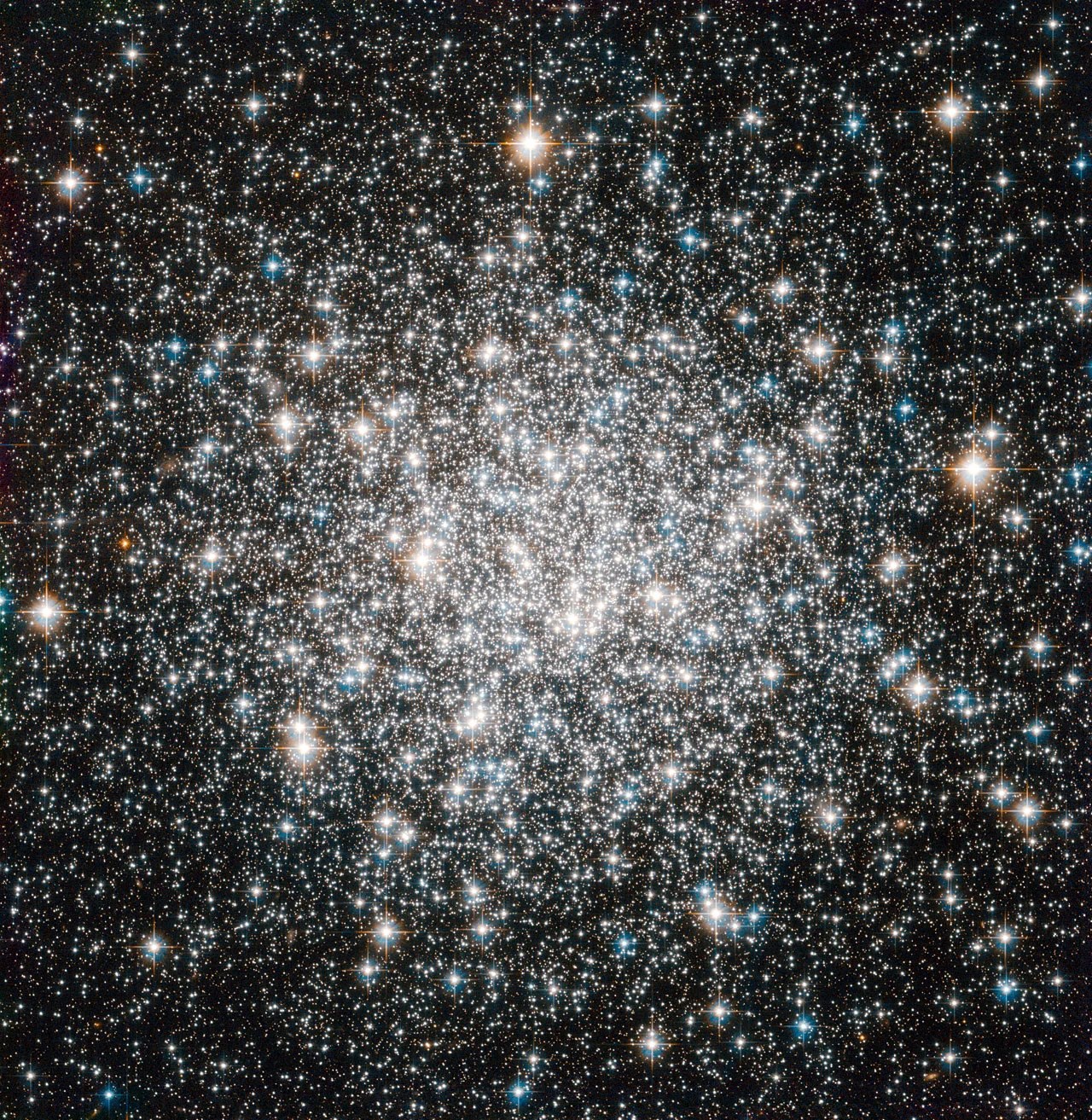 A bright cluster of white stars, more concentrated near the center.