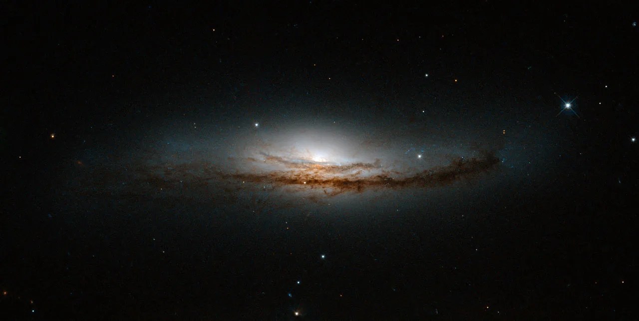 This new hubble image is centered on ngc 5793, a spiral galaxy over 150 million light-years away in the constellation of libra.