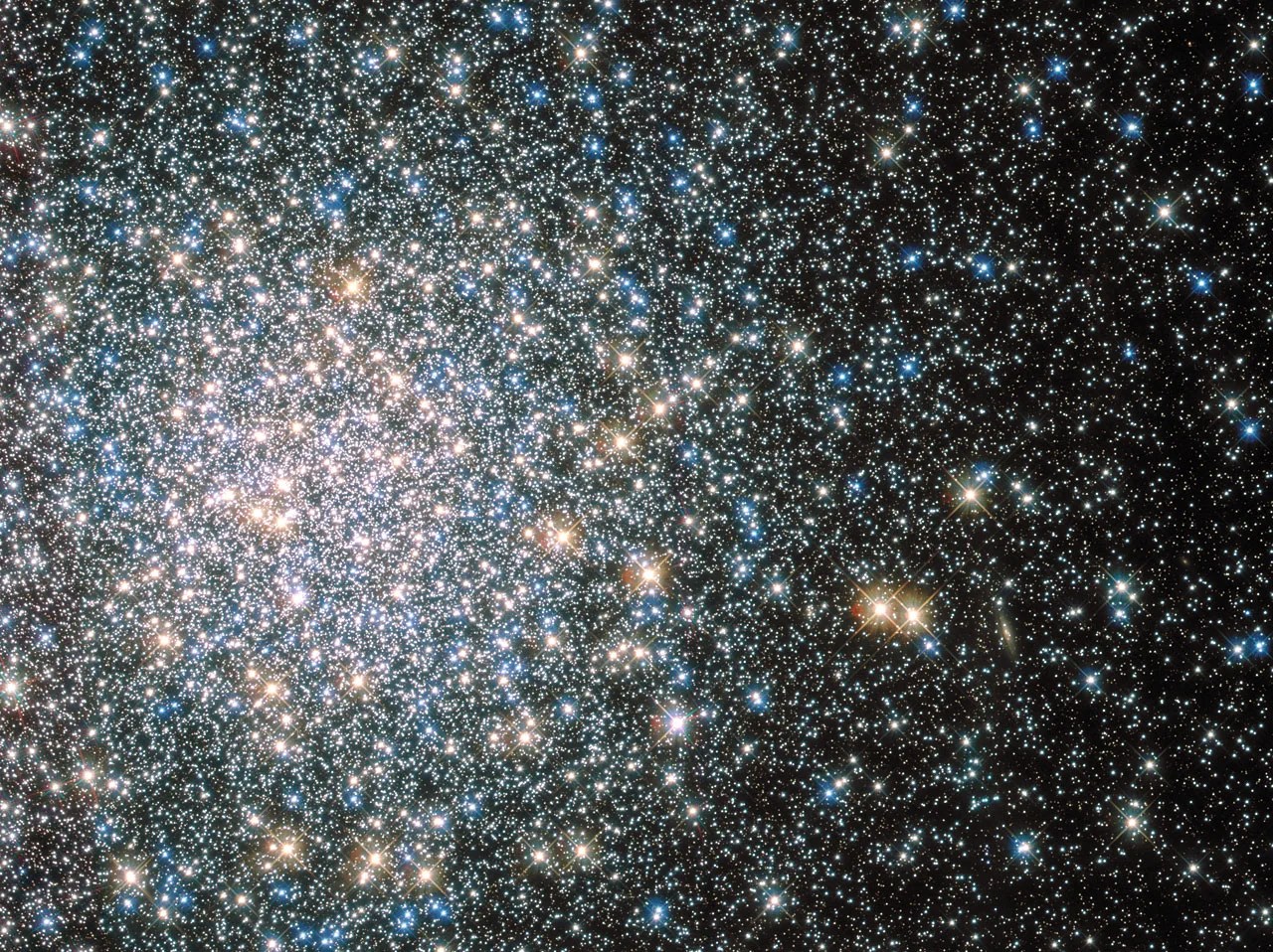 A cluster of multi-colored stars on black