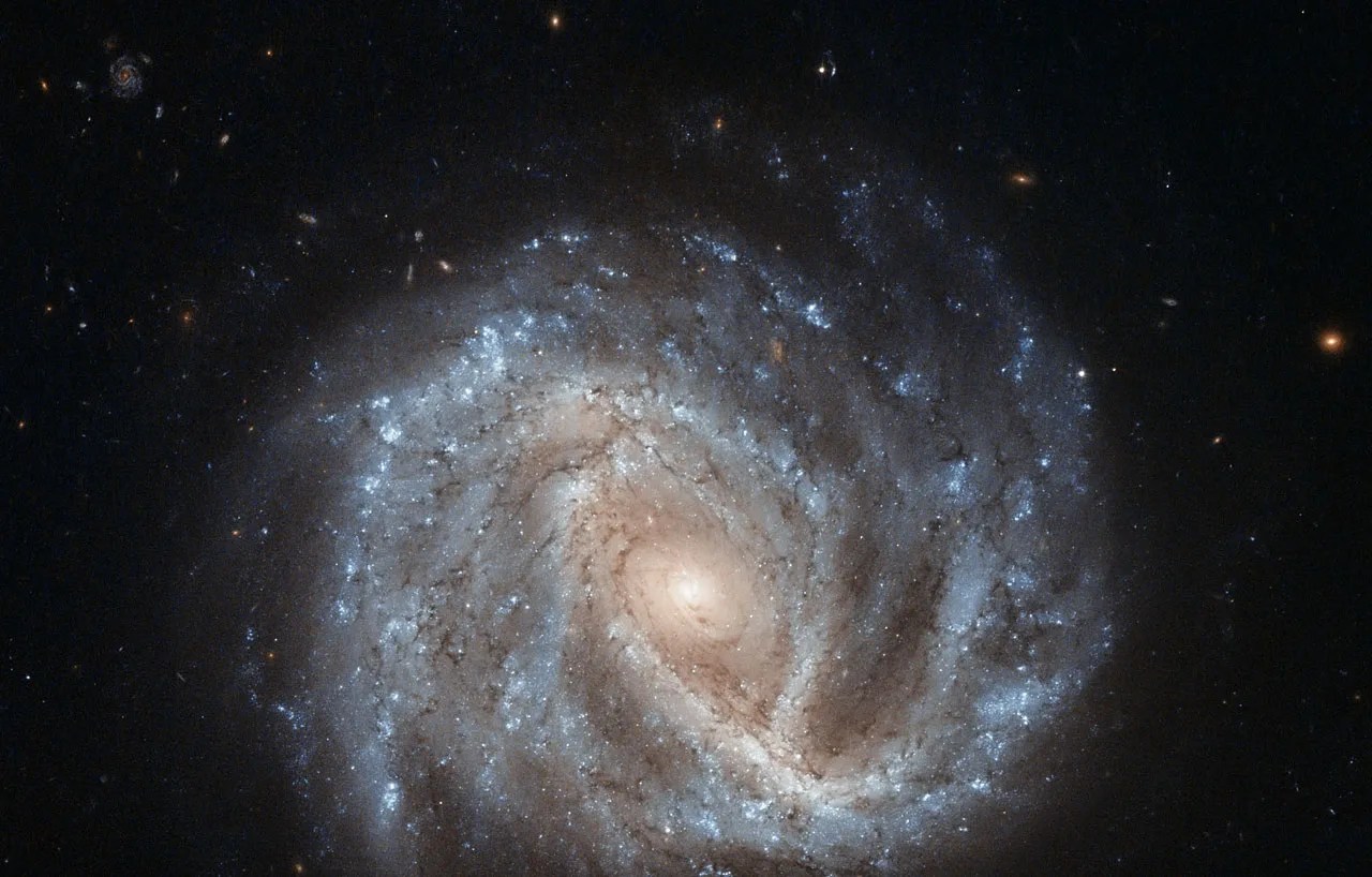 Spiral galaxy with brightest spot at center and arms extending out into deep space