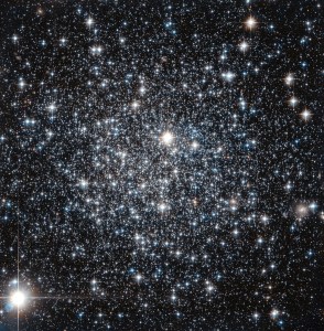 A sprinkling of mostly whitish and a few reddish stars on black.
