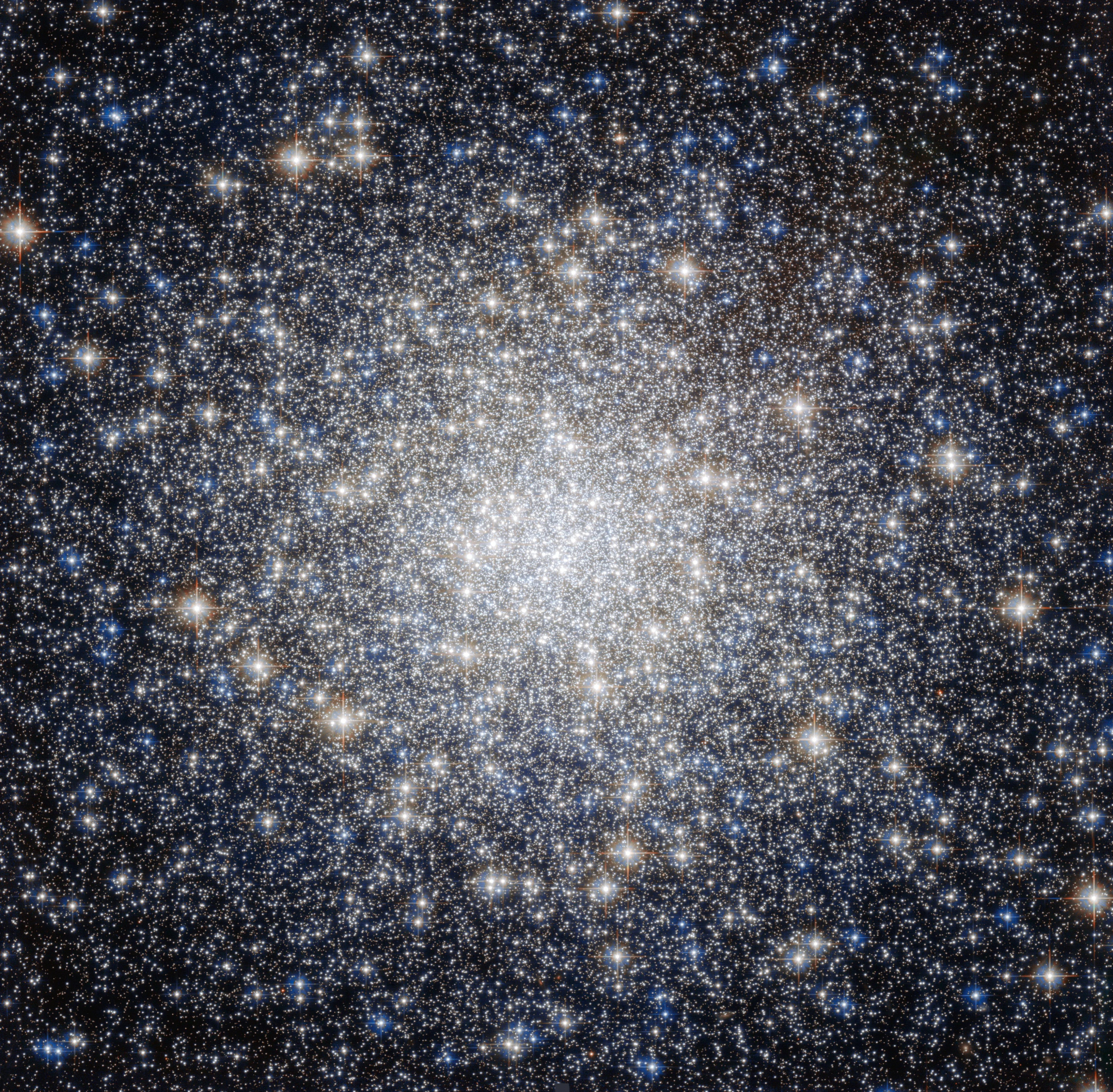 A bright cluster of stars, more concentrated at the center.