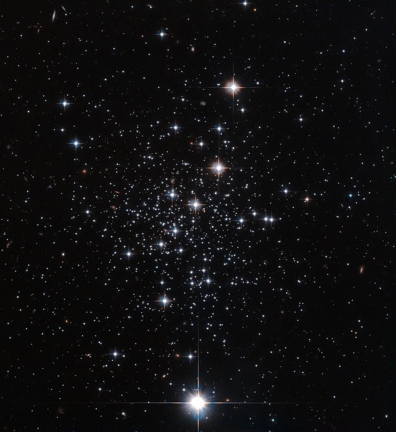 A scattered collection of bright white stars against the black background of space. The stars vary in brightness and some have t-shaped diffraction spikes.