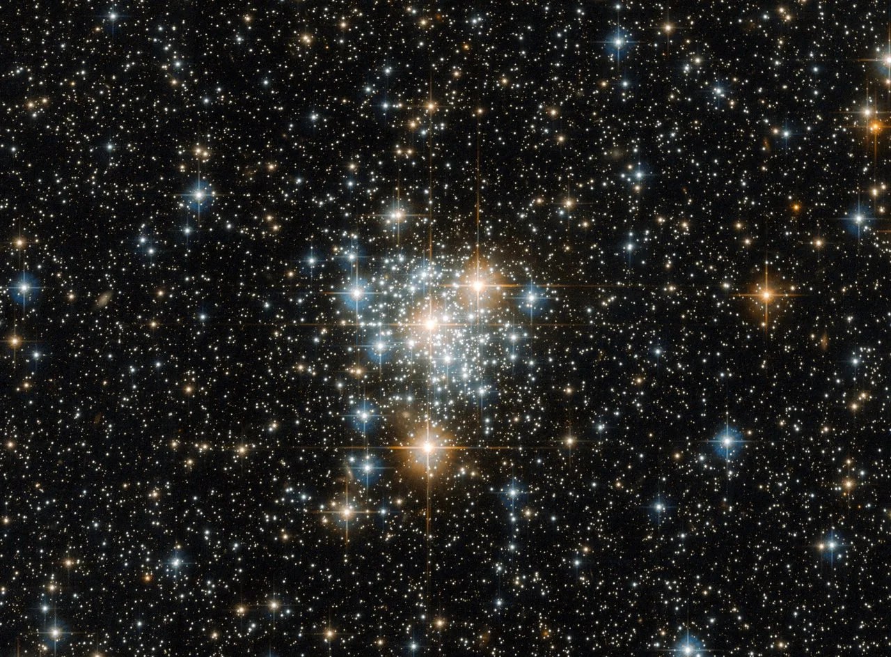 Bright cluster of stars on a dark starfield