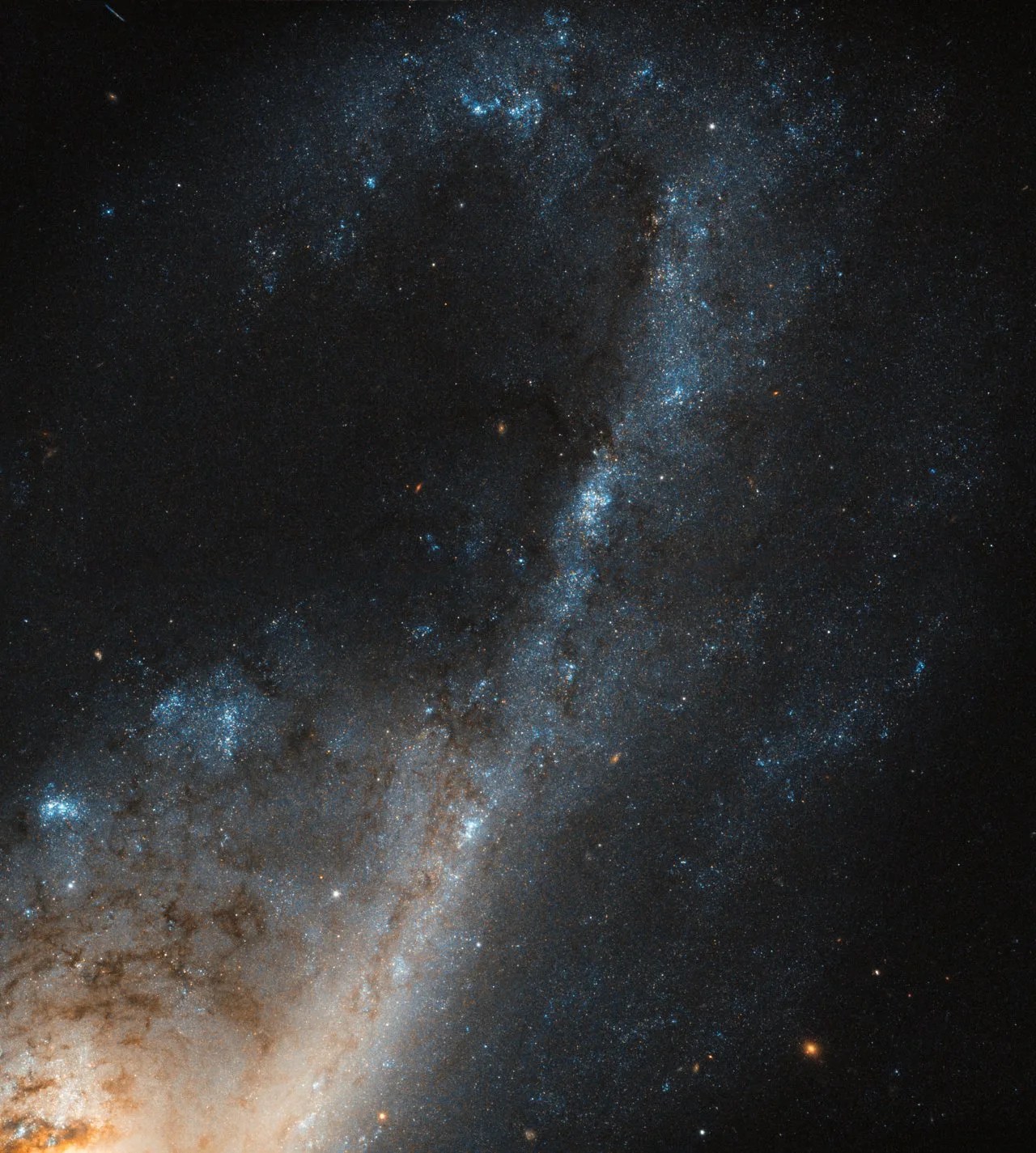 Closup of spiral galaxy arm with blue clusters