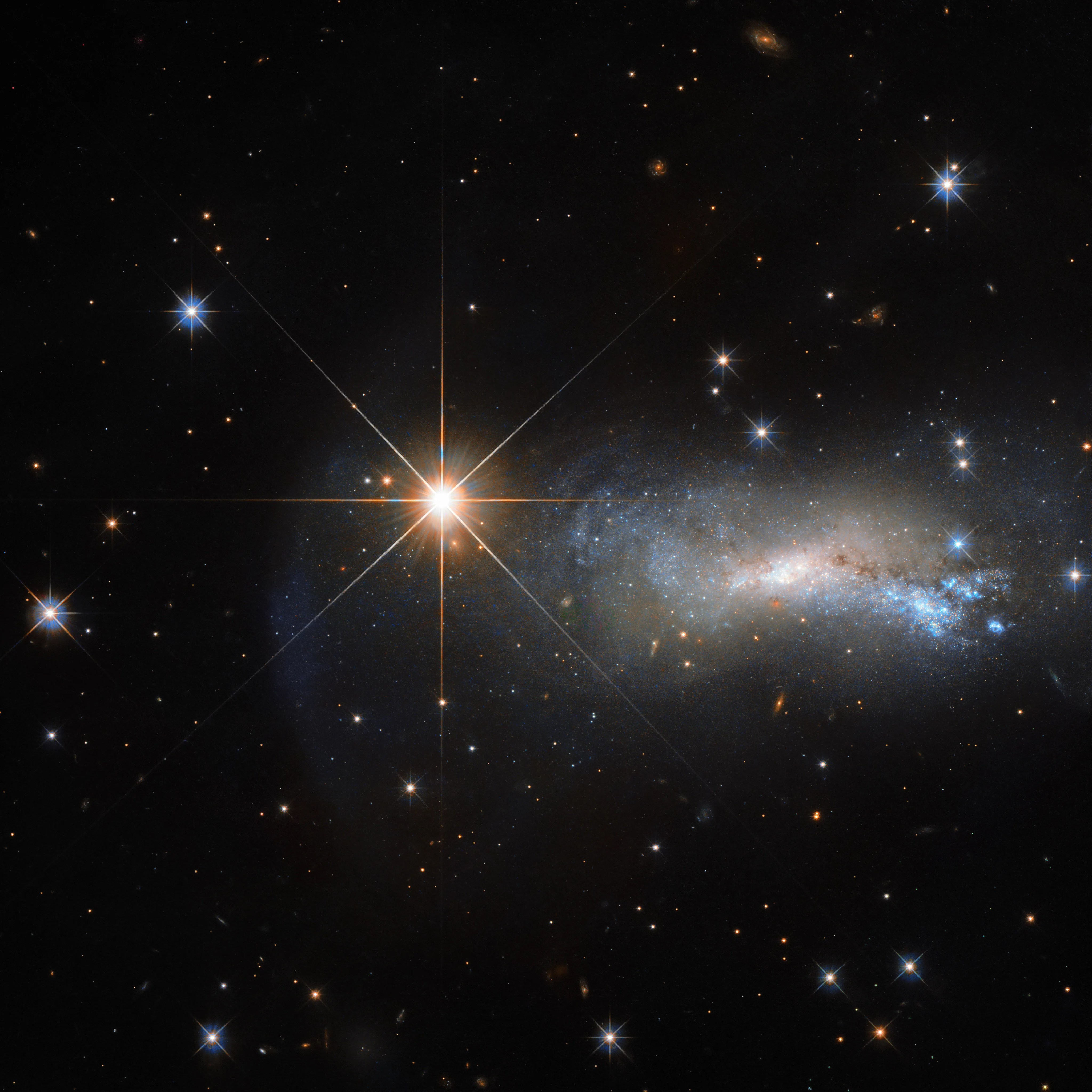 a bright star and a dimmer galaxy.