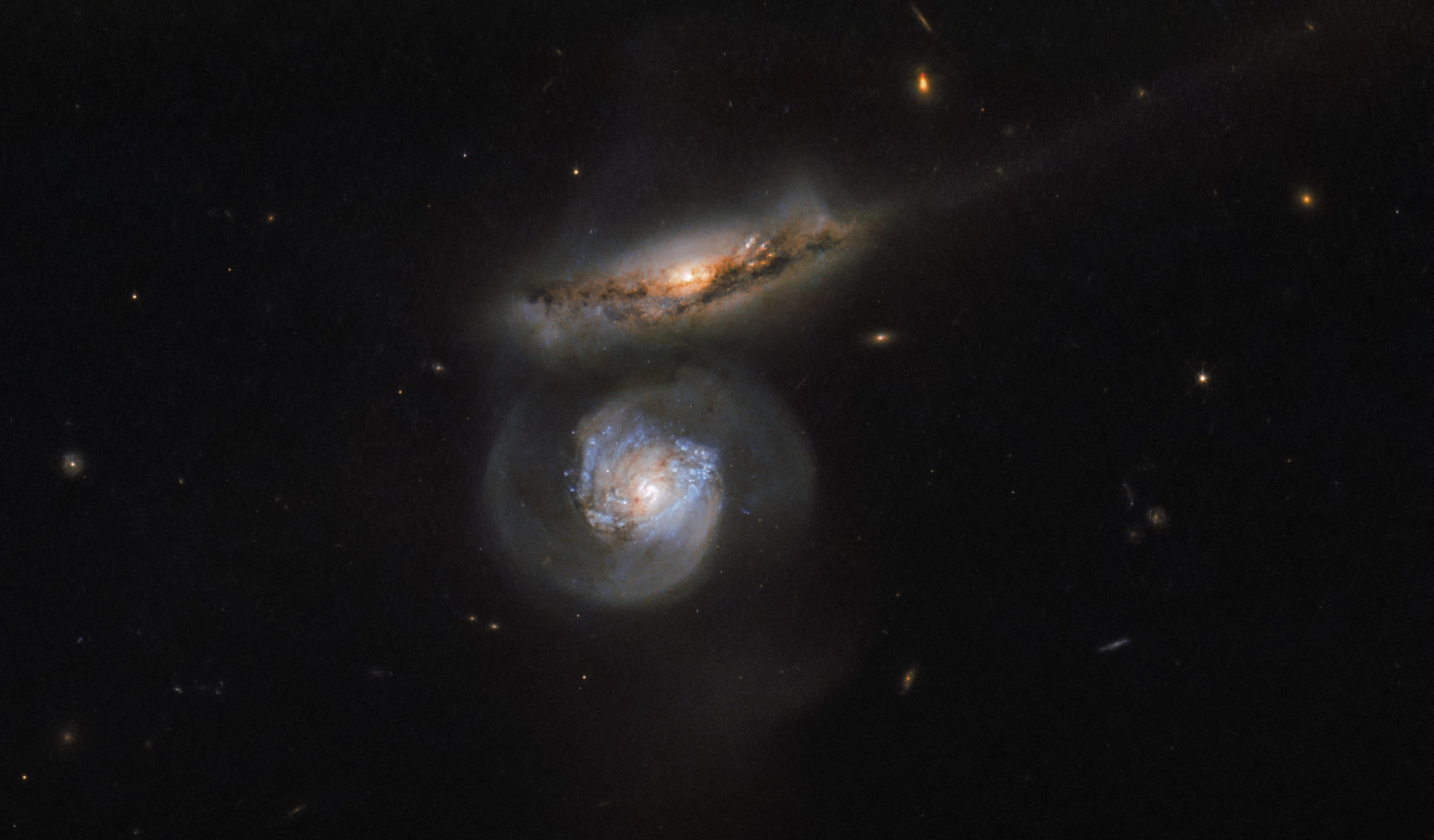 Two galaxies, one head on and one edge on