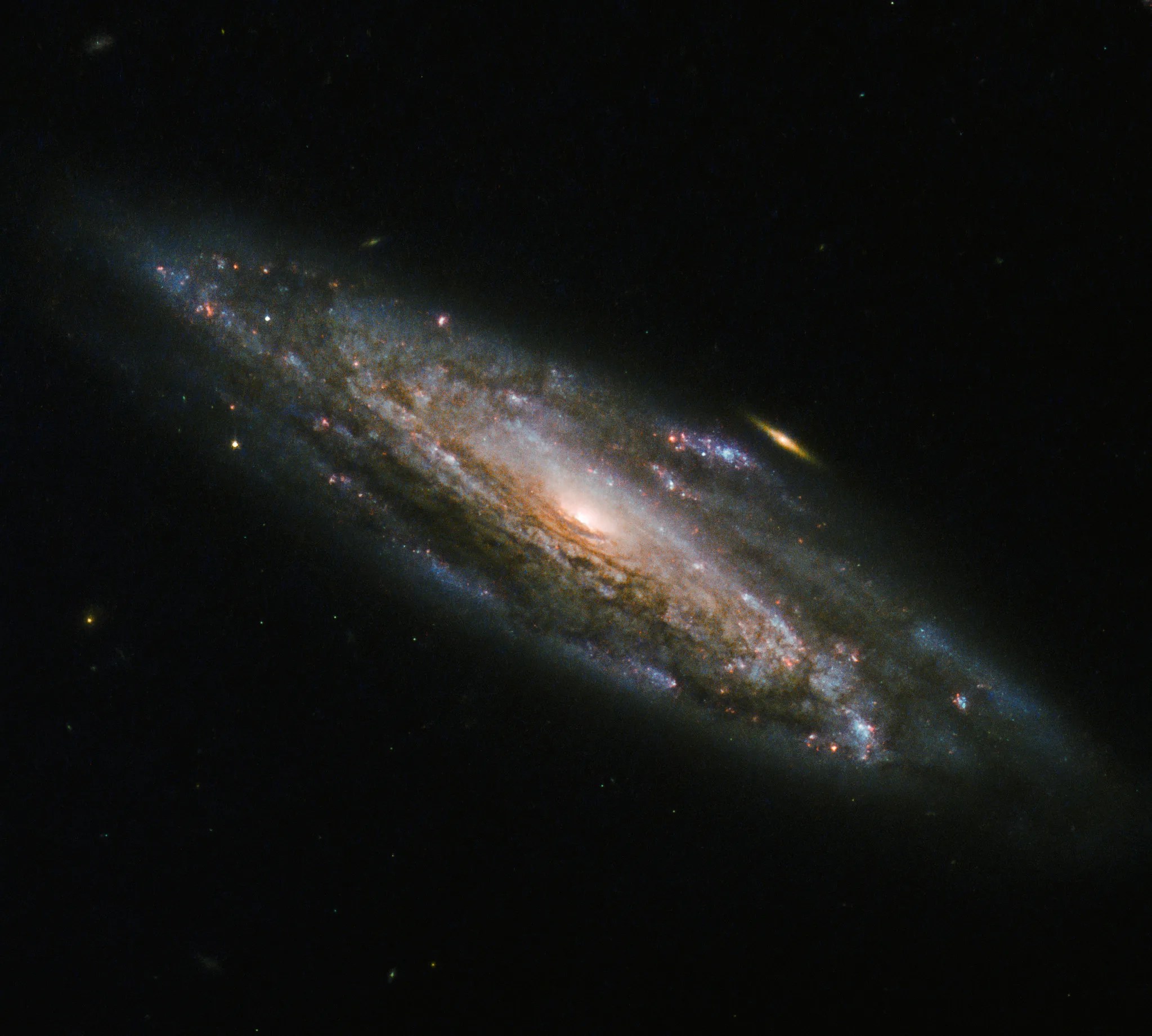 Spiral galaxy with small golden galaxy in background