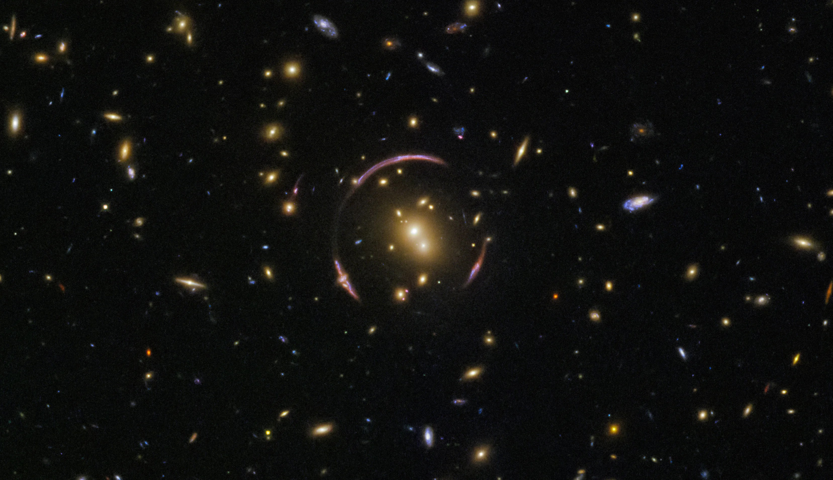 Pink broken ring circling a cluster of galaxies