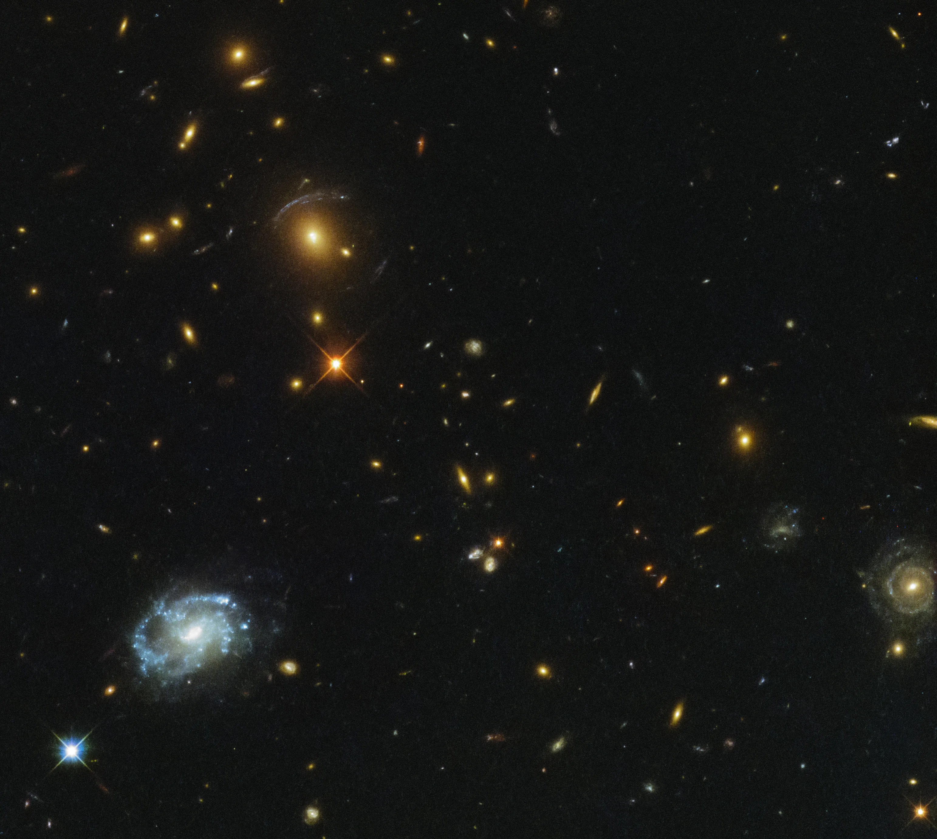 Galaxies and stars sprinkled over a black field