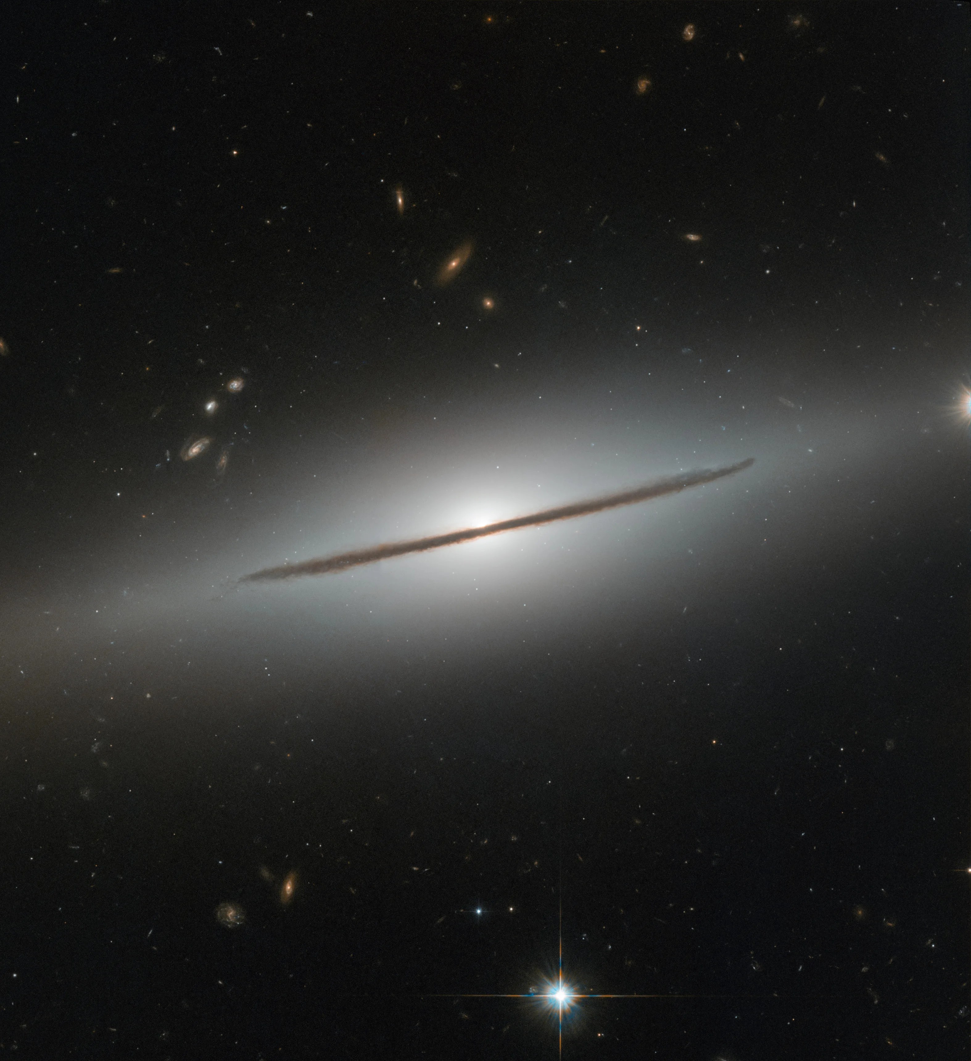 Bright white galaxy with a black bar along the centerline