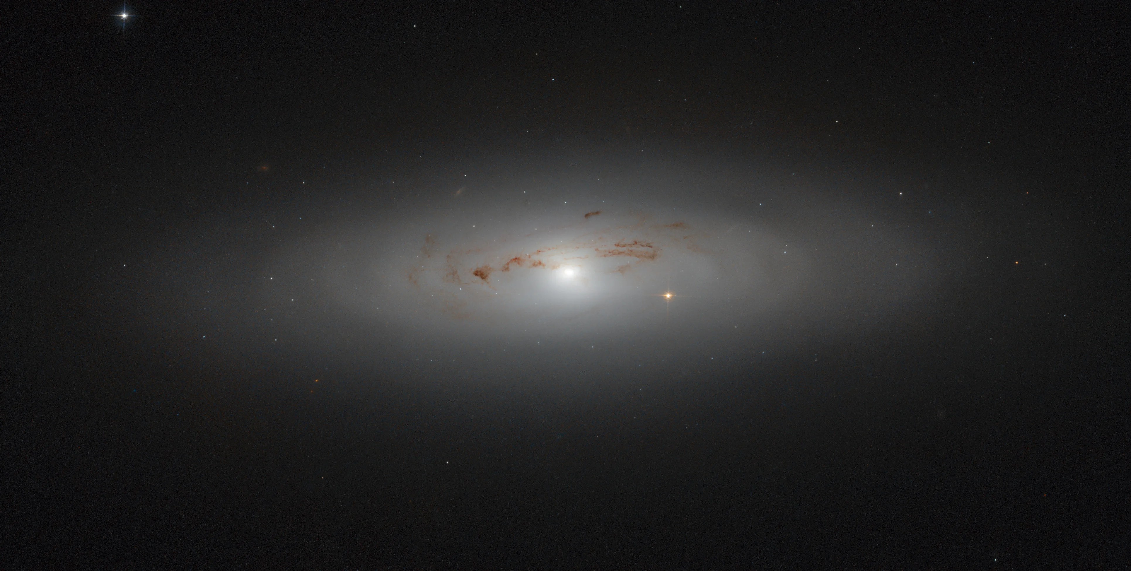 Hazy galaxy with dusty streaks in the center