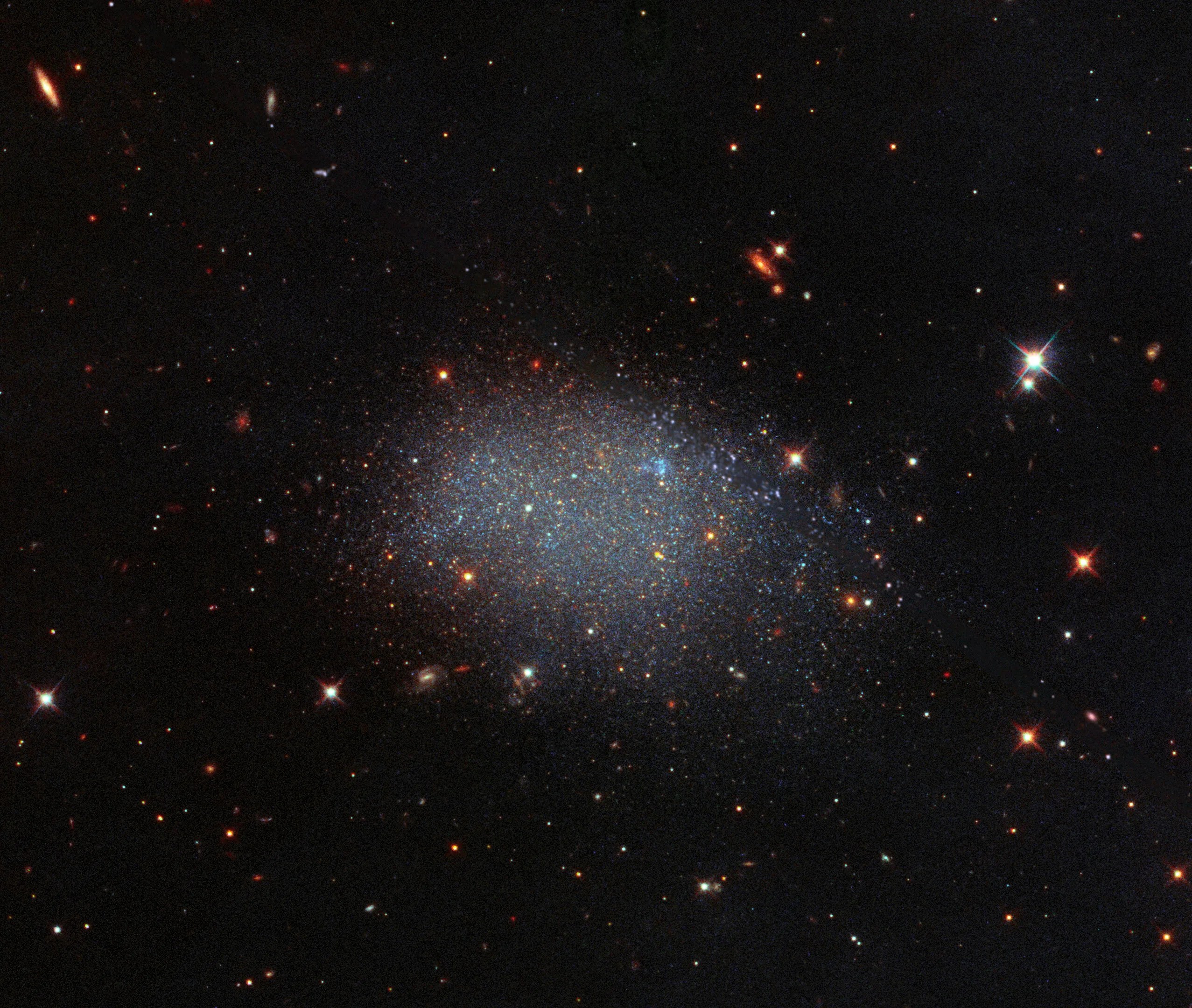 Galaxy kk 246 looks like glitter spilled across a black velvet sheet (hubble image)