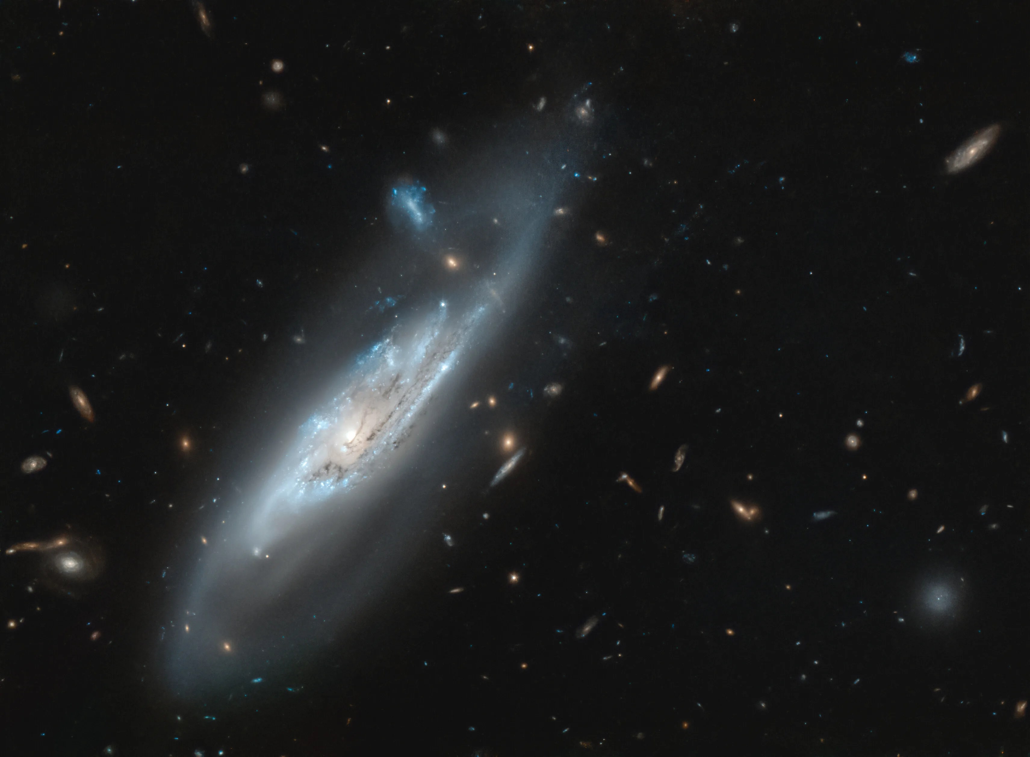 Bright, vaguely bluish, spiral galaxy ngc 4848 against black backdrop of space