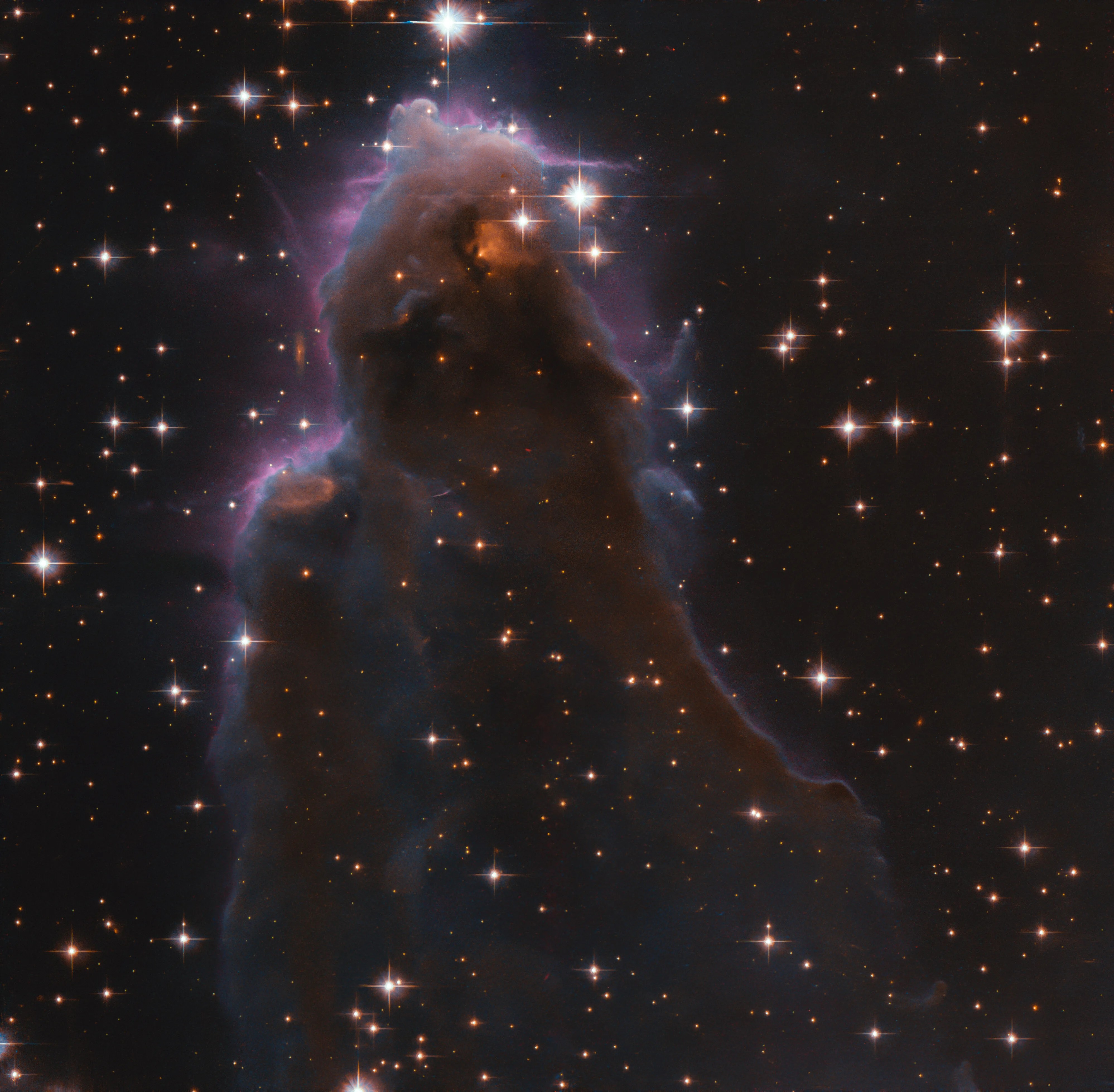 Whisp-like, purple-hued view of star-forming region j025157.5+600606 against black backdrop of space, as seen by hubble