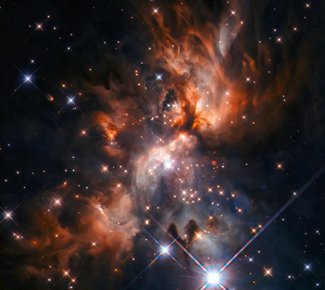 This image from the nasa/esa hubble space telescope features afgl 5180, a beautiful stellar nursery.