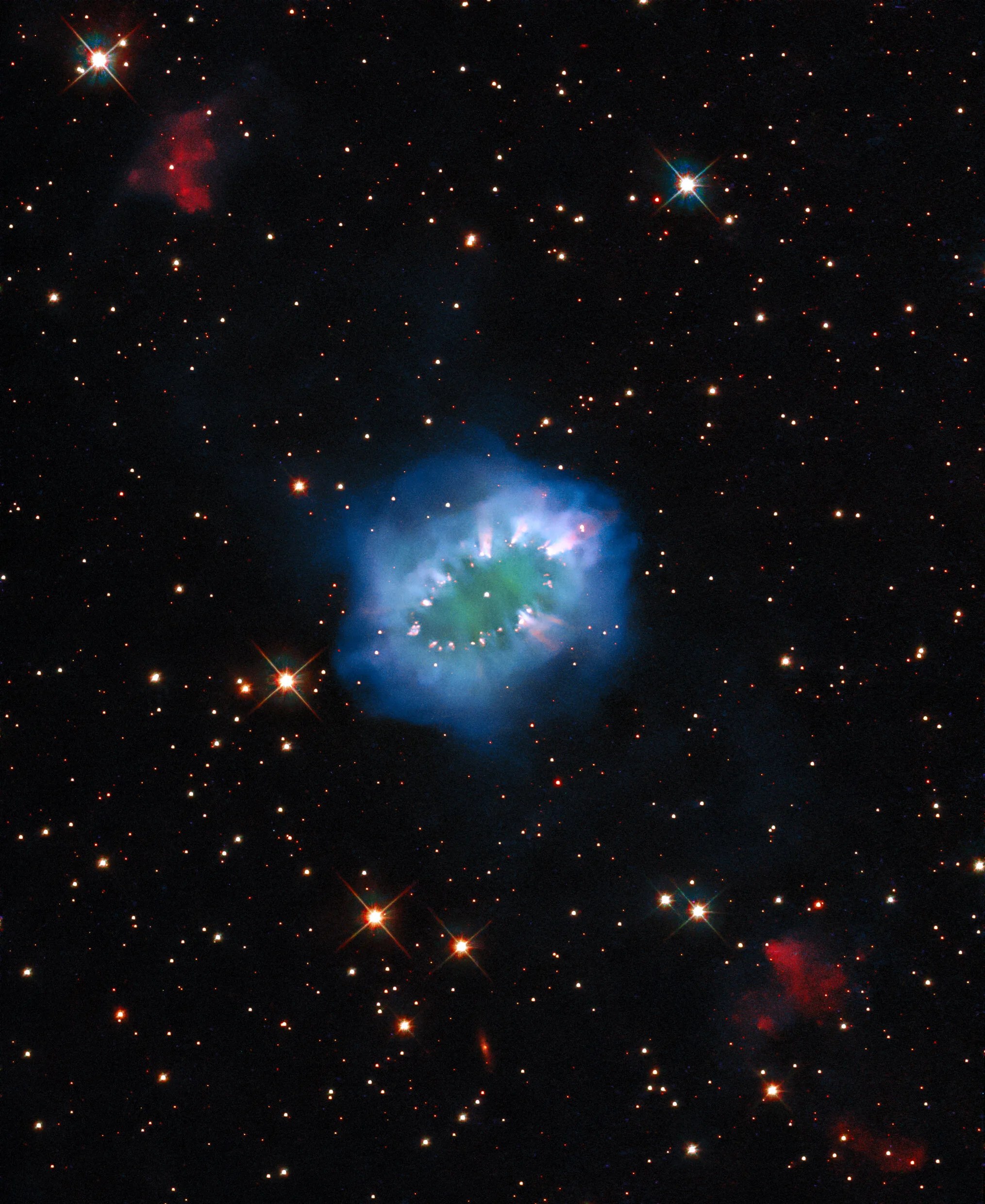 The interaction of two doomed stars has created this spectacular ring adorned with bright clumps of gas ¬– a diamond necklace of cosmic proportions.