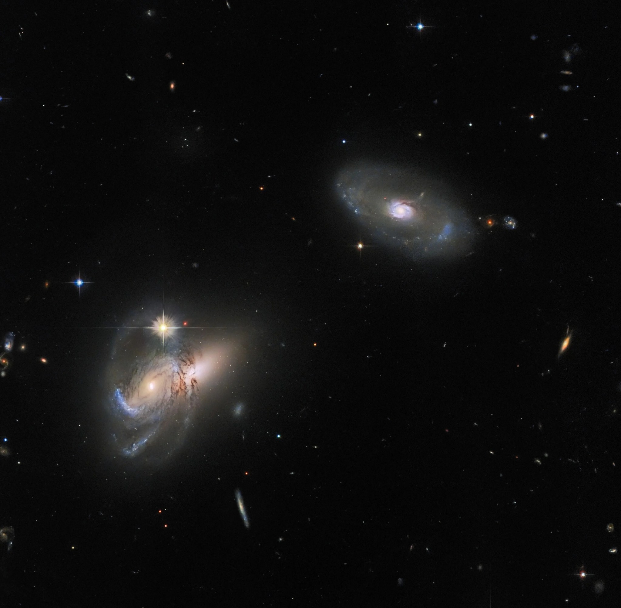 Two spiral galaxies in space.