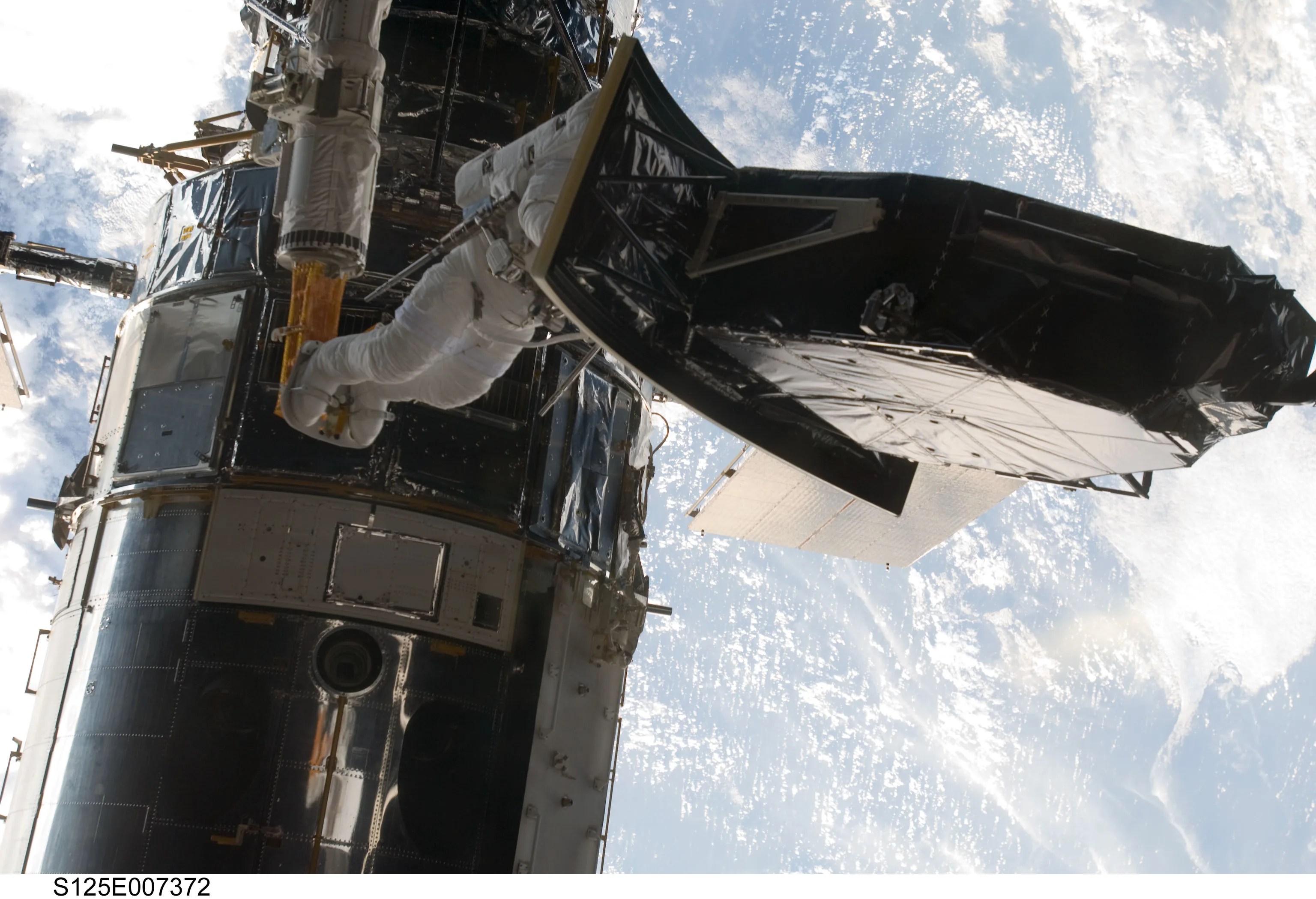 astronaut works on Hubble