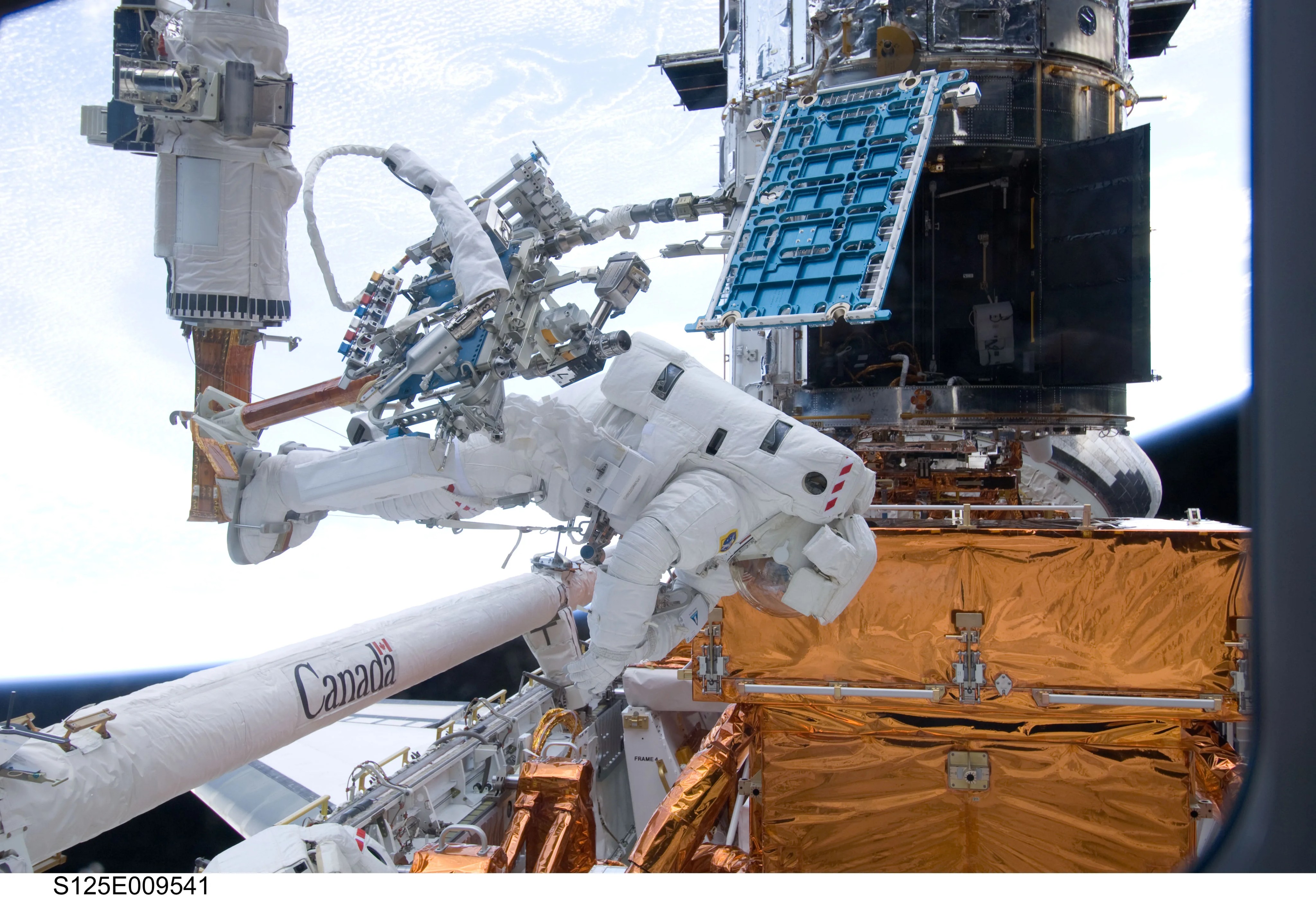 astronauts working on Hubble
