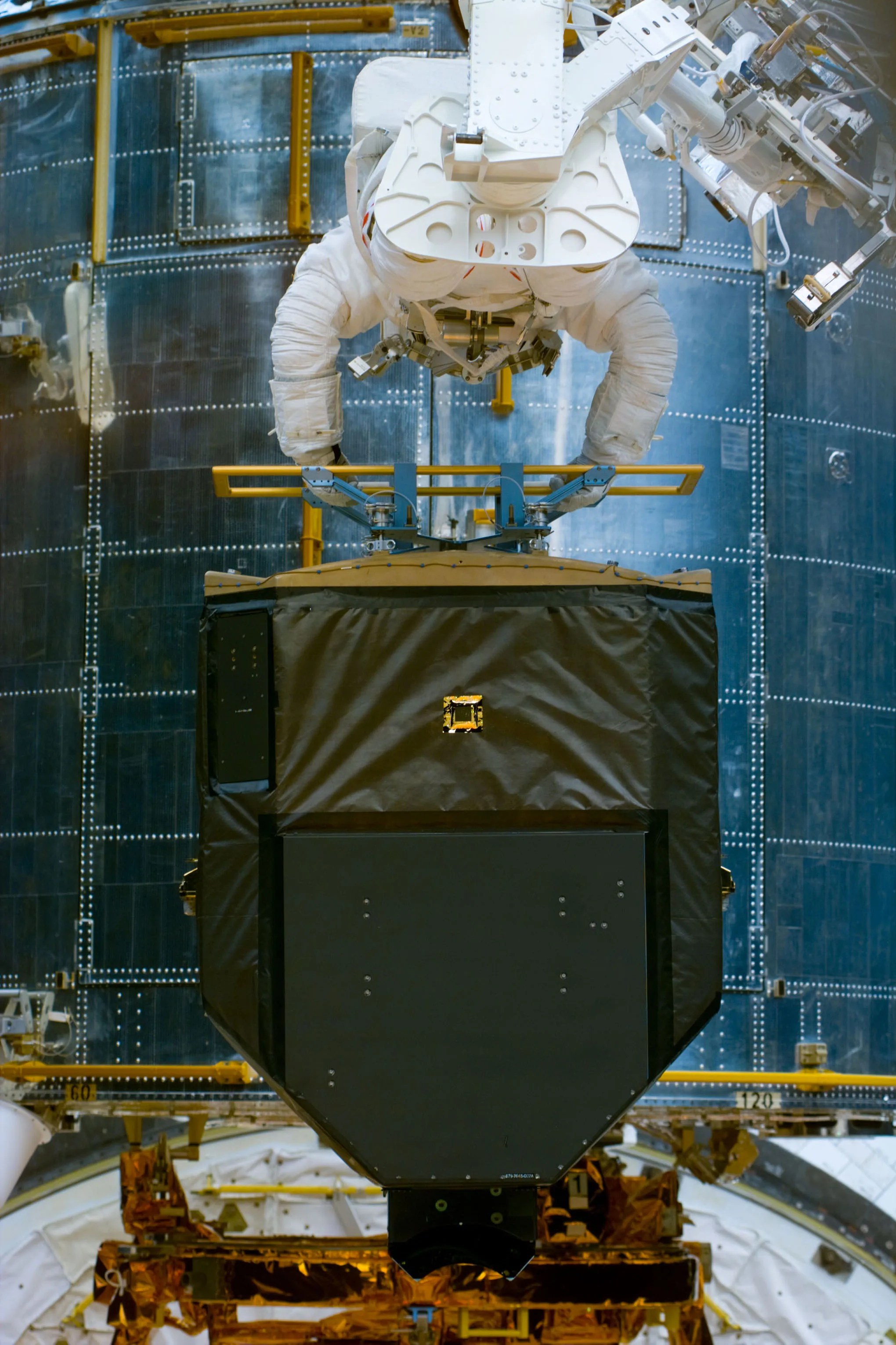 Astronaut Joseph Tanner working on the Hubble Space Telescope.