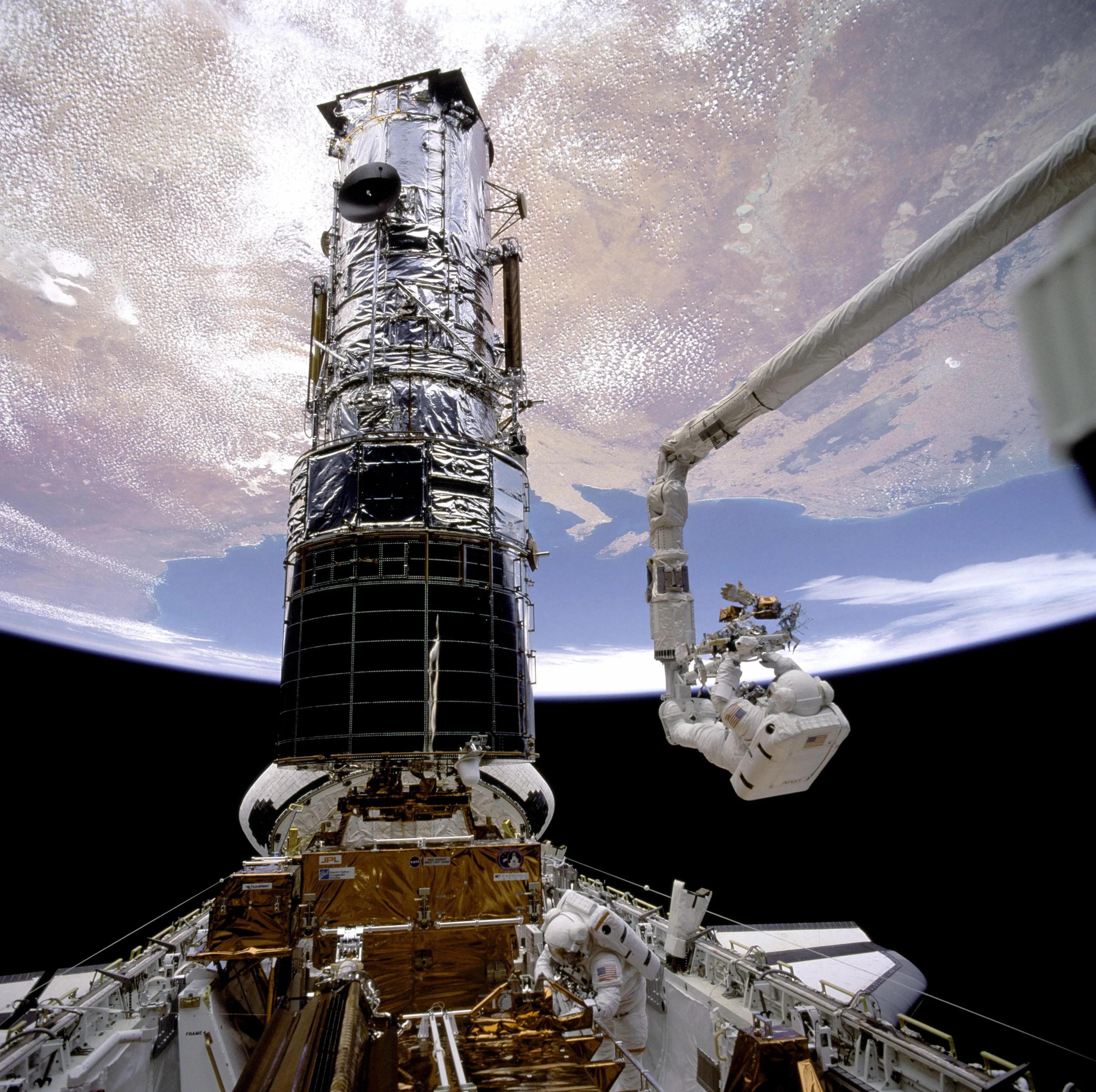 Hubble telescope undergoing astronaut repairs on first servicing mission