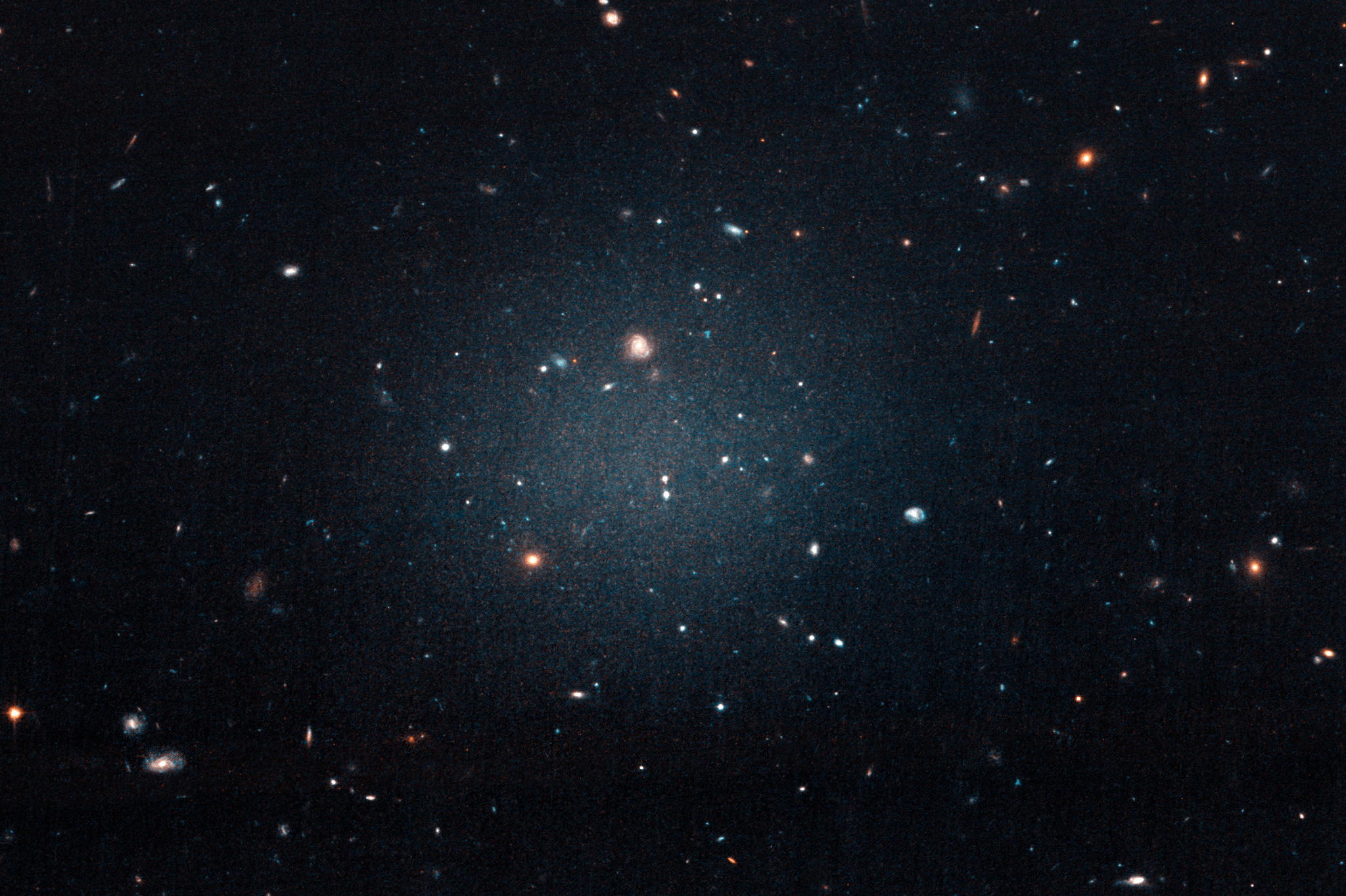 diffuse white blur across a field of galaxies