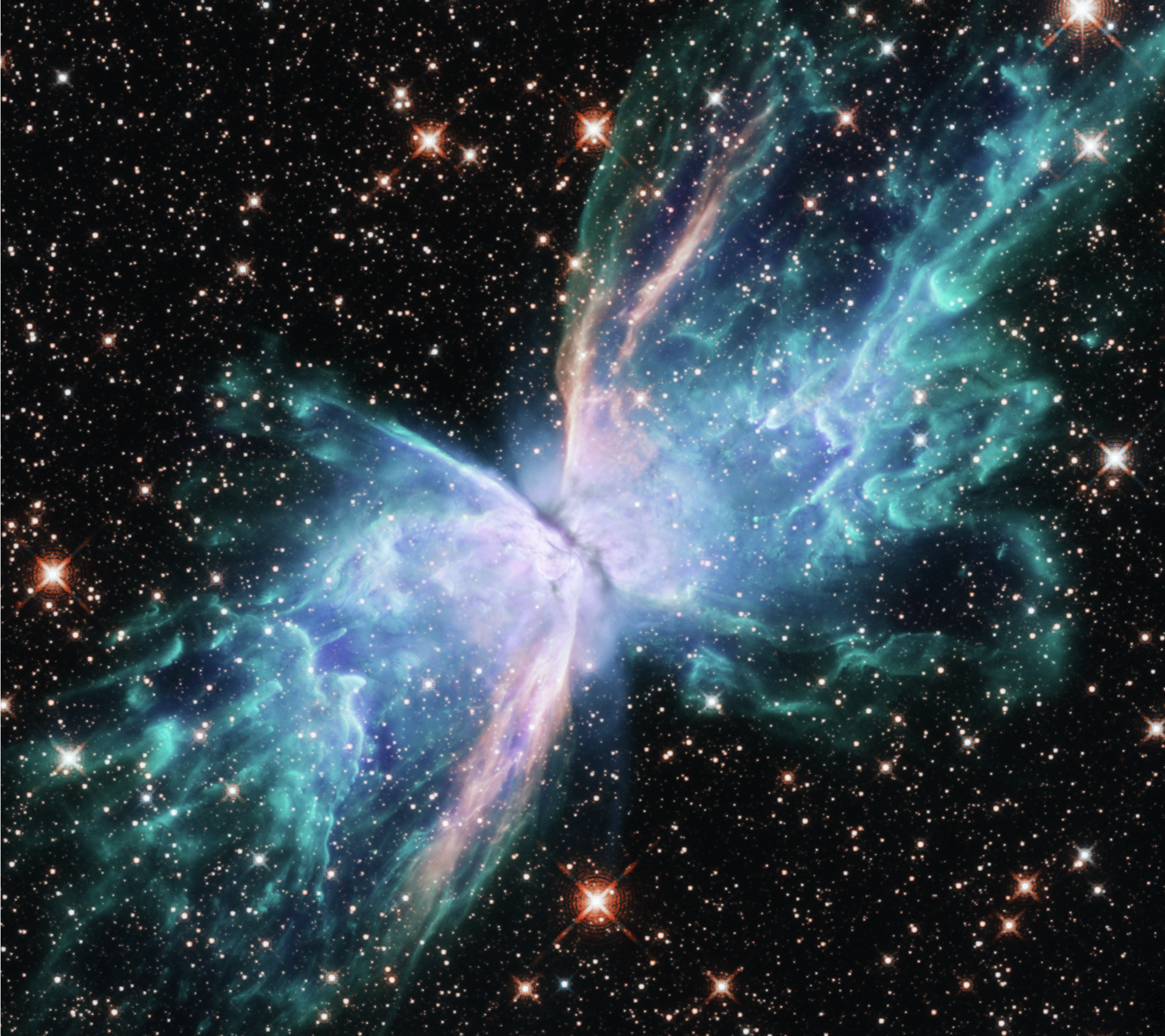 Resembling the shape of a butterfly, two lobes of gas and dust stretch across a starry black background in shades of green and blue, growing paler toward where they meet.