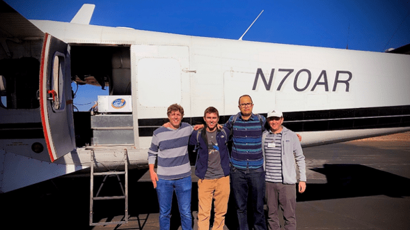 Photo of some members of the WASSR team loading science gear onto an aircraft