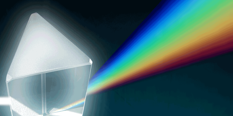 This photo of a prism show white light bending (or refracting) as it travels through the glass prism forming a rainbow.