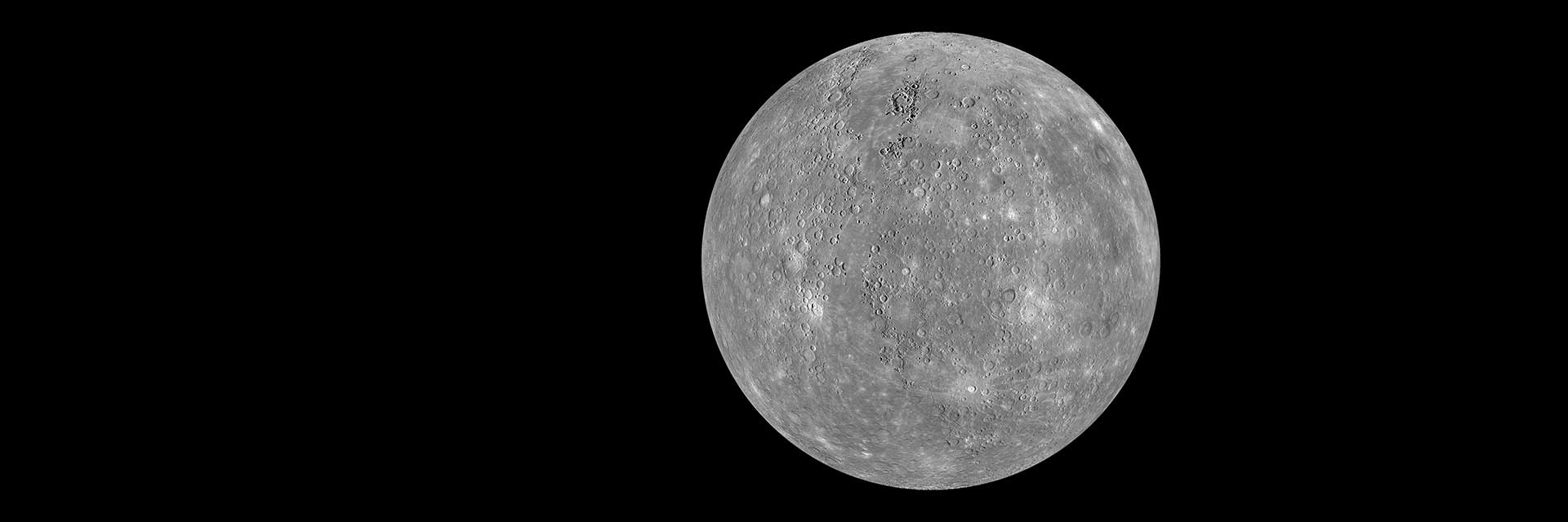 Gray planet Mercury with craters and rays of material ejected by impactors like asteroids.