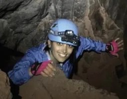 Researcher Sanaz Esmaeili crawls through a lava tube in California to map its size and shape.