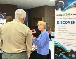 Sharon Bowers talks to a man at the eClips exhibit booth.